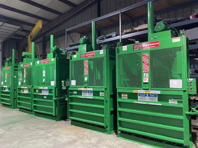 Industrial baler compressing cardboard for recycling - Texas baler sales and service