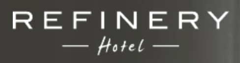 Sign displaying the word 'REFINERY' with 'Hotel' written underneath.