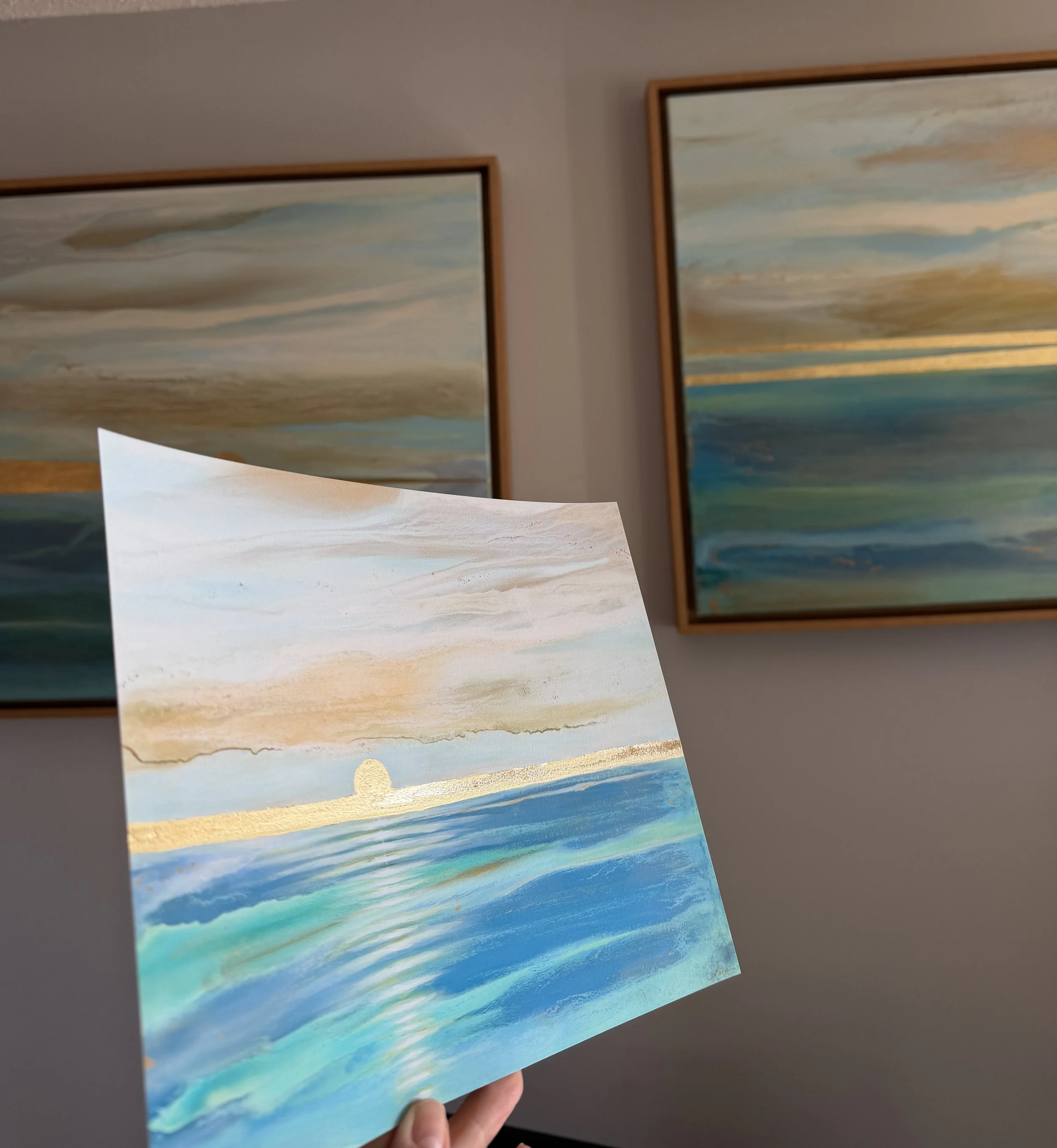 Coastal landscape in blue, turquoise and teal colors with a gold horizon line.