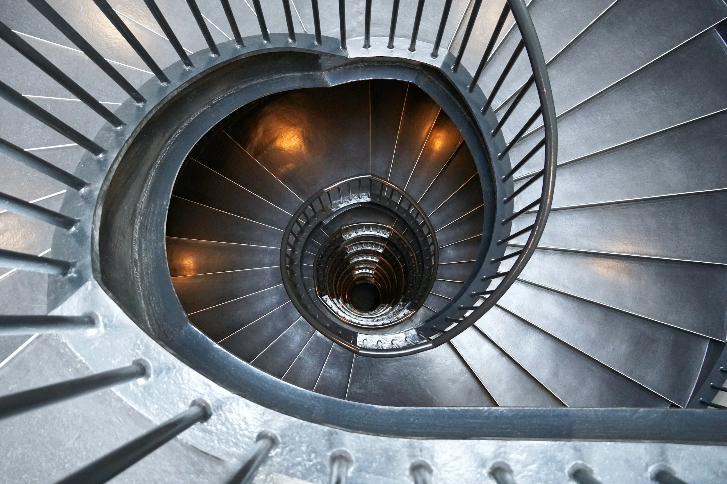 A winding circular staircase looking down from the top