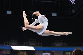 Sports Performance Anxiety A gymnast performing a leap on a balance beam during a competition. Worried about sports performance anxiety