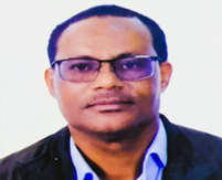 Portrait of a man wearing glasses, a dark blazer, and a light blue shirt.