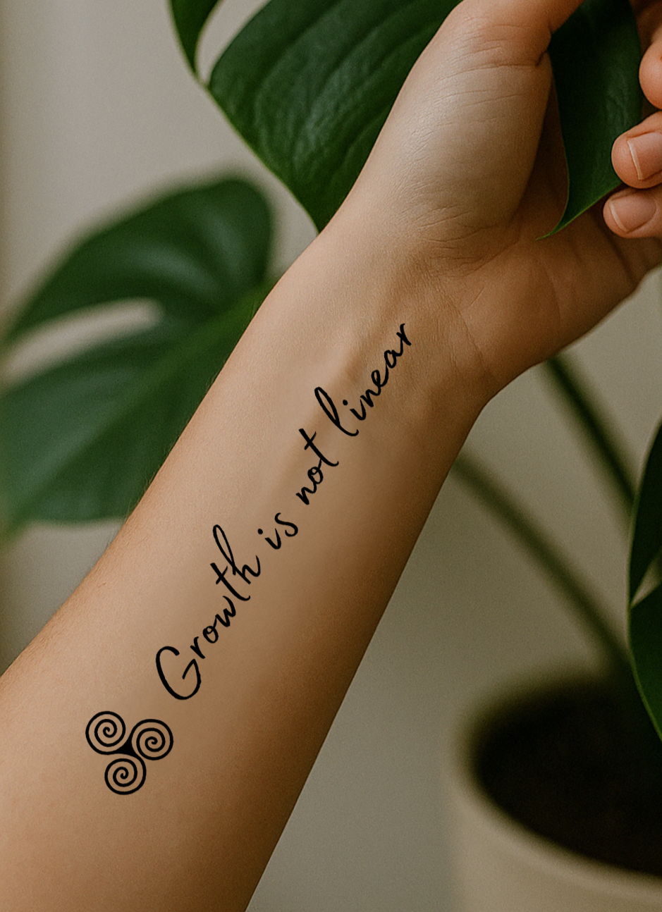 Inner forearm holding a monstera has a tattoo that says Growth is not linear. Next to it you can see the triple spiral. 
