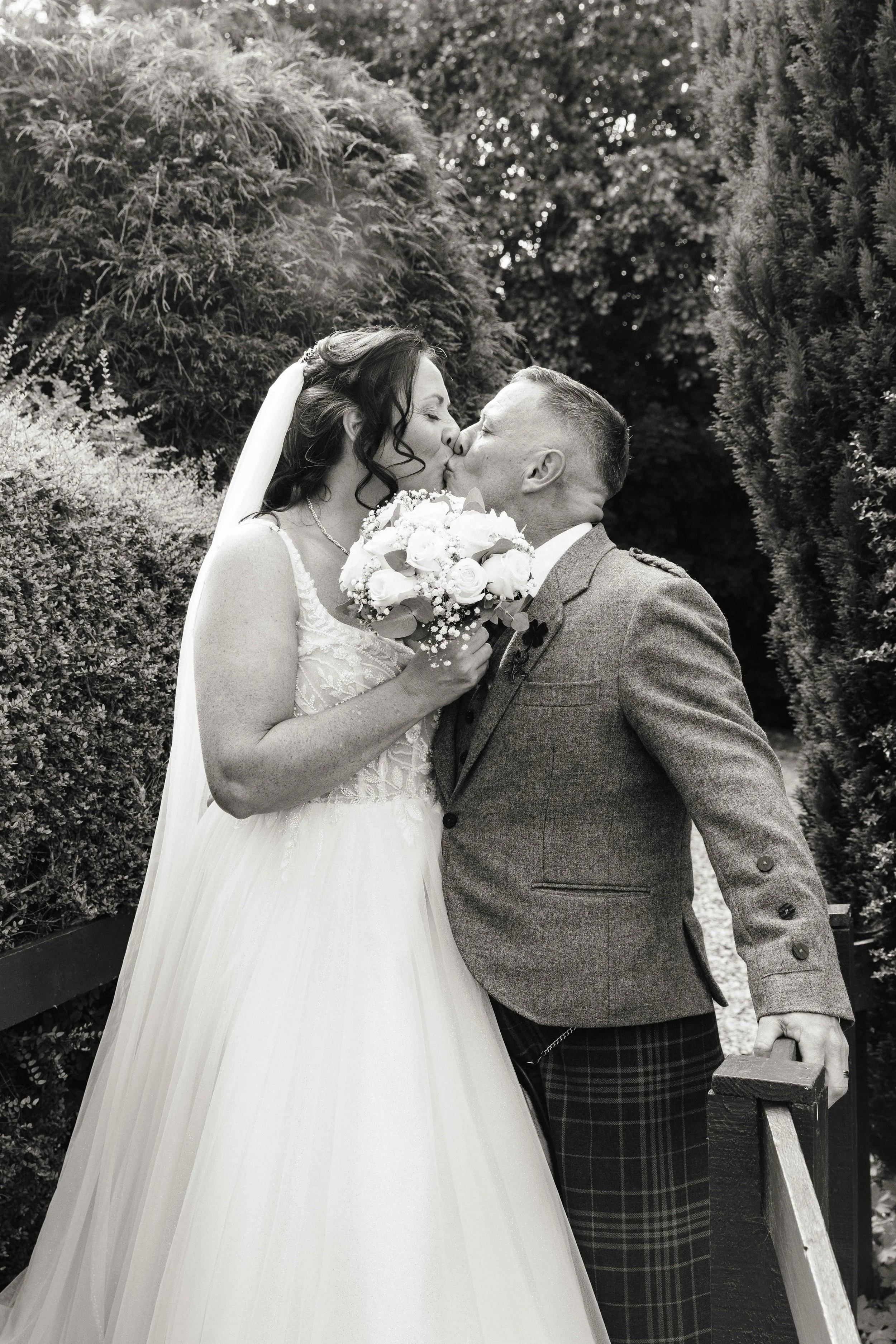 Newly wed couple holding flowers. Glasgow based Love Burds Media specialises in affordable wedding photography and short form video content across Scotland. 