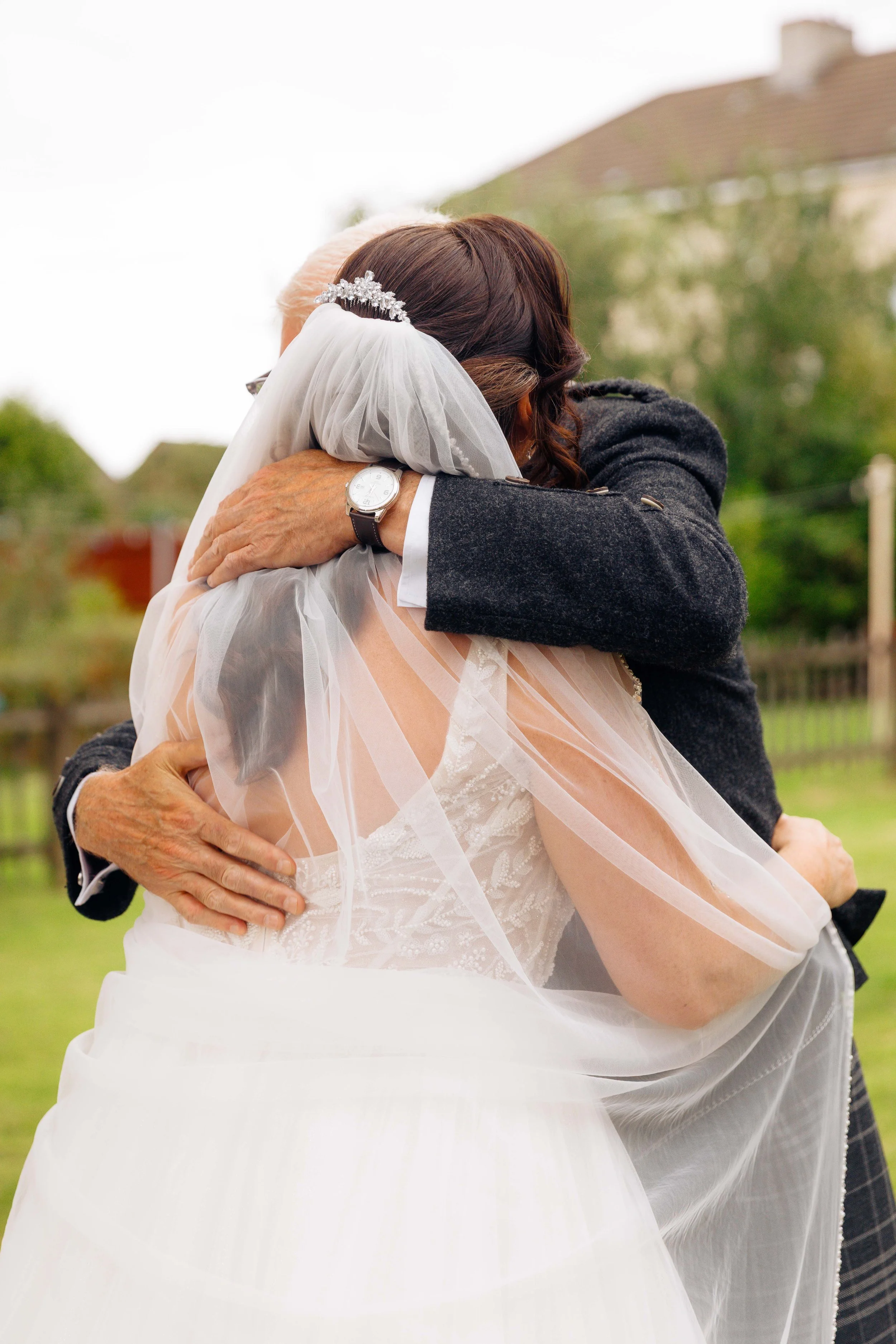 Bride hugs father during 'first look'. Glasgow based Love Burds Media specialises in affordable wedding photography and short form video content across Scotland. 