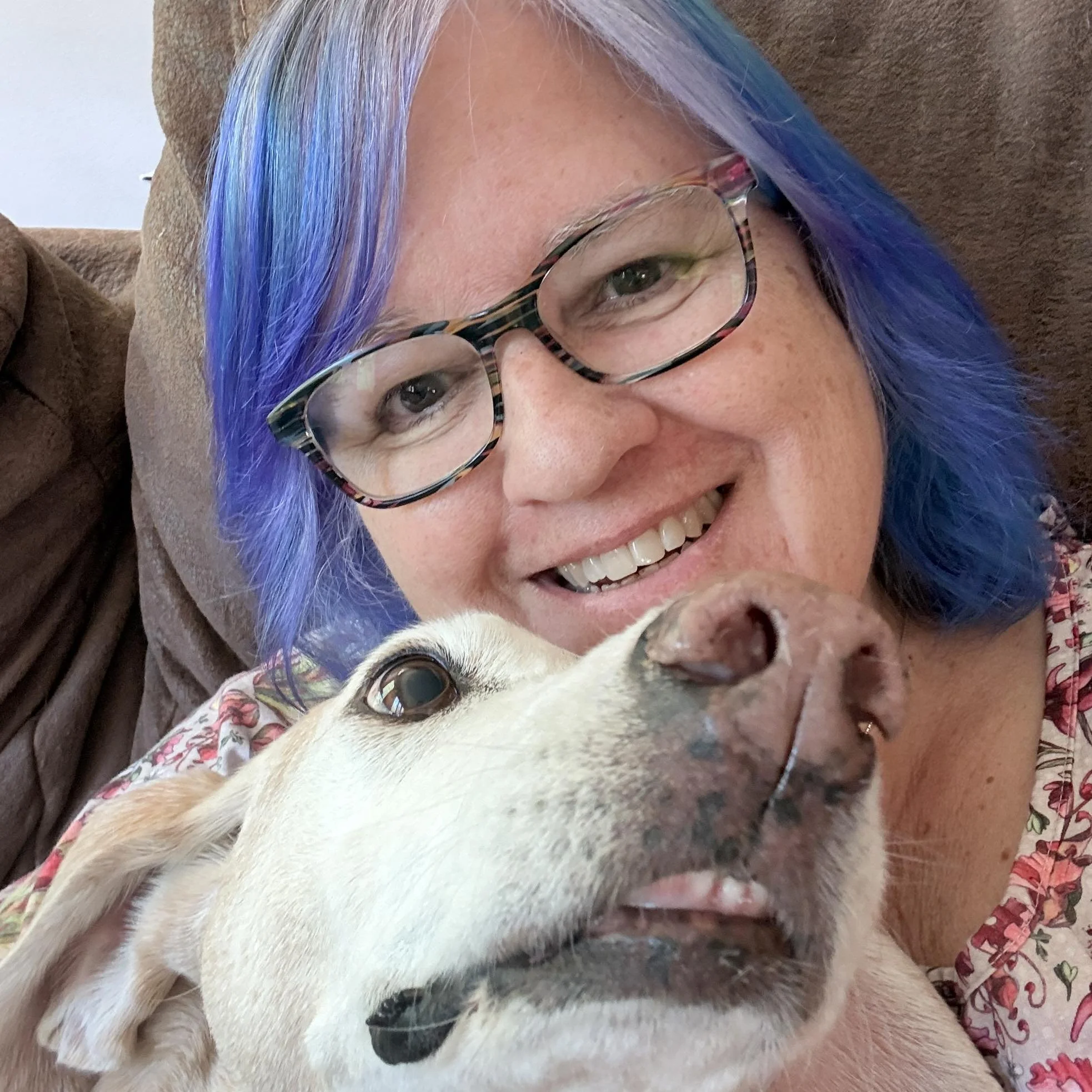 Woman with purple hair with white dog