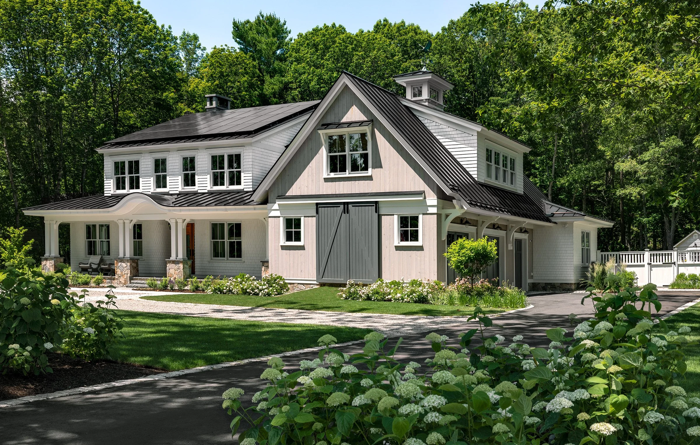 Oak Road Estate features a stunning inground pool, a modern barn-style farmhouse, and a beautifully cultivated garden. Designed by Sea Laurel Landscape Architecture, this property blends refined outdoor living with timeless New England charm.