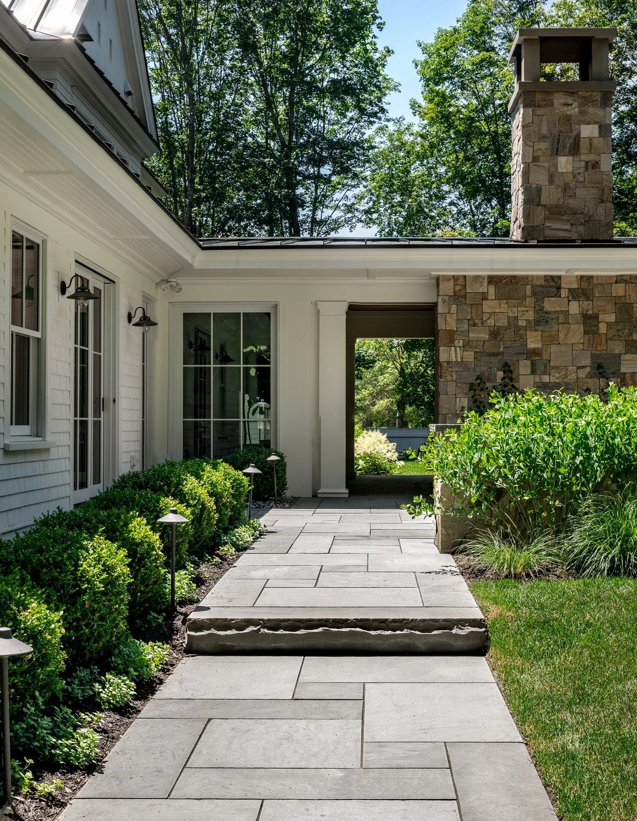Oak Road Estate features a stunning inground pool, a modern barn-style farmhouse, and a beautifully cultivated garden. Designed by Sea Laurel Landscape Architecture, this property blends refined outdoor living with timeless New England charm.