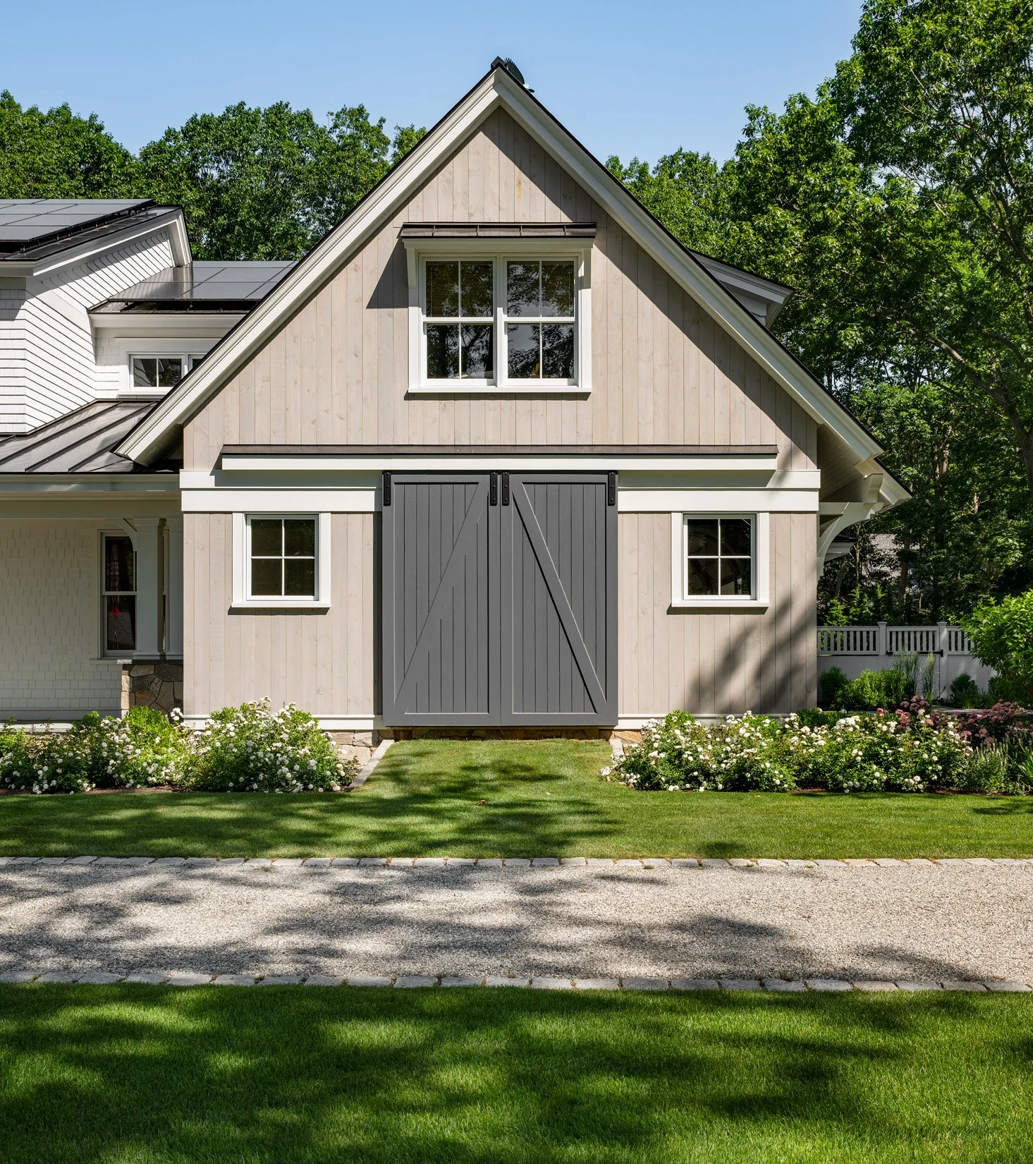 Oak Road Estate features a stunning inground pool, a modern barn-style farmhouse, and a beautifully cultivated garden. Designed by Sea Laurel Landscape Architecture, this property blends refined outdoor living with timeless New England charm.
