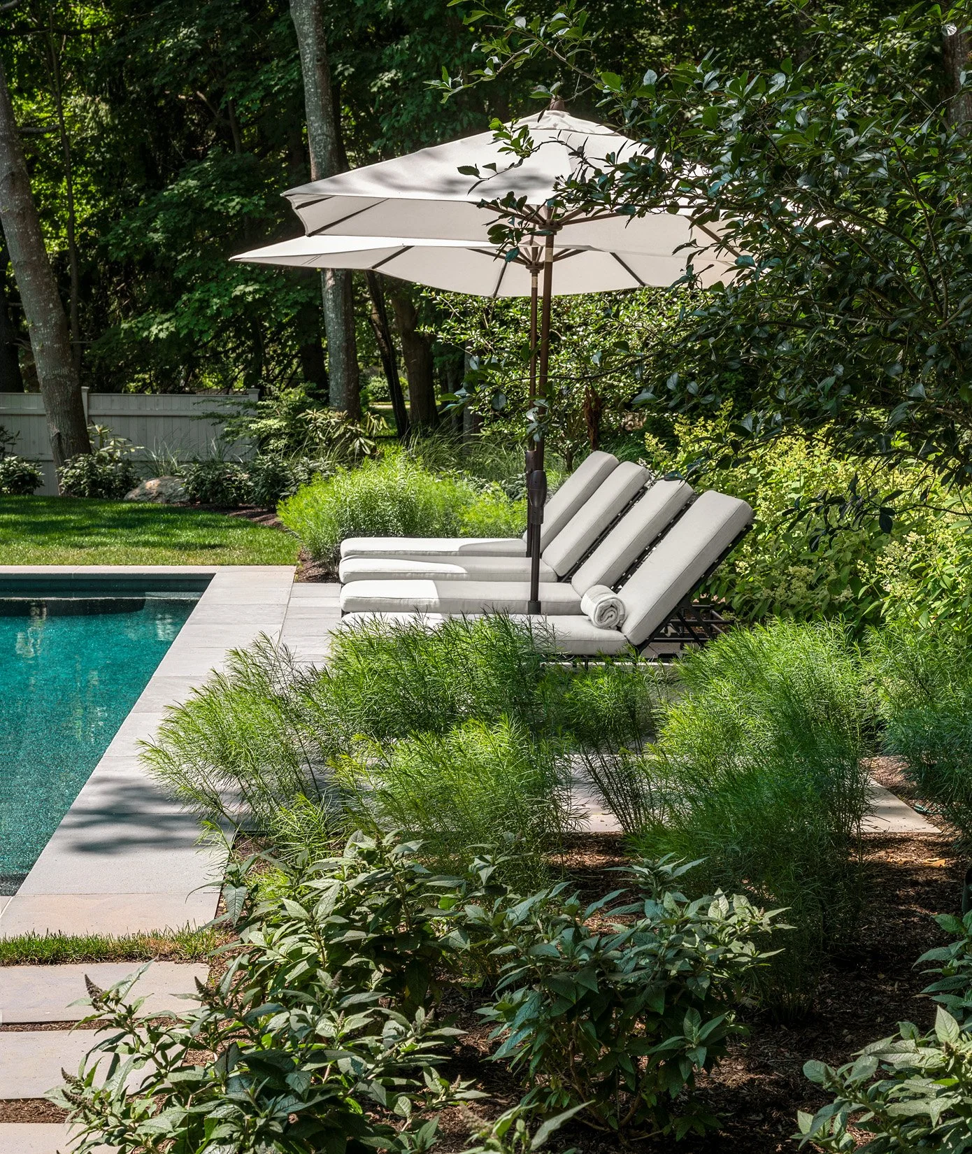 Oak Road Estate features a stunning inground pool, a modern barn-style farmhouse, and a beautifully cultivated garden. Designed by Sea Laurel Landscape Architecture, this property blends refined outdoor living with timeless New England charm.