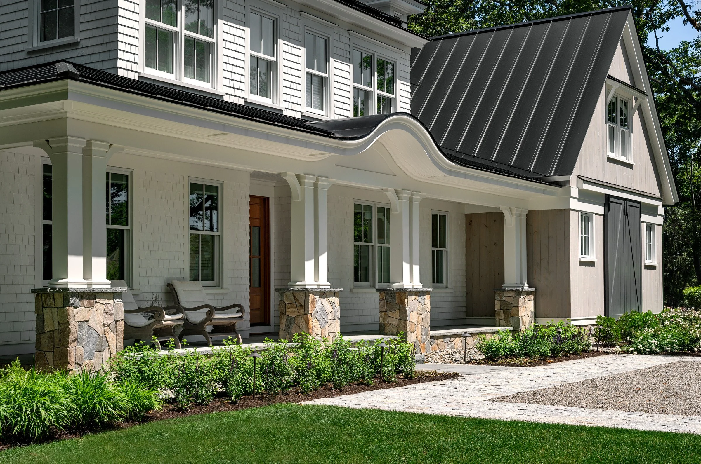 Oak Road Estate features a stunning inground pool, a modern barn-style farmhouse, and a beautifully cultivated garden. Designed by Sea Laurel Landscape Architecture, this property blends refined outdoor living with timeless New England charm.