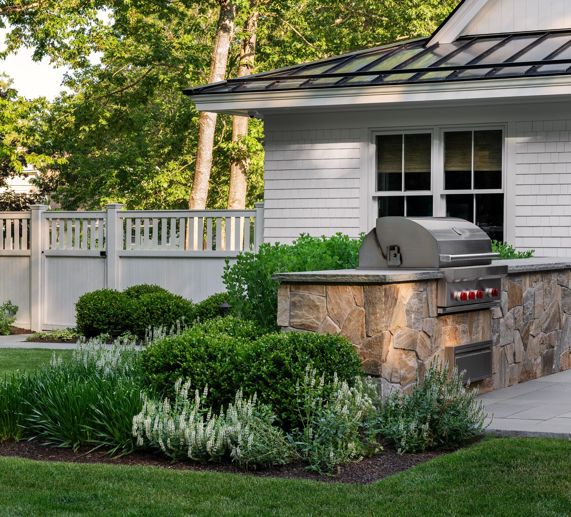 Oak Road Estate features a stunning inground pool, a modern barn-style farmhouse, and a beautifully cultivated garden. Designed by Sea Laurel Landscape Architecture, this property blends refined outdoor living with timeless New England charm.
