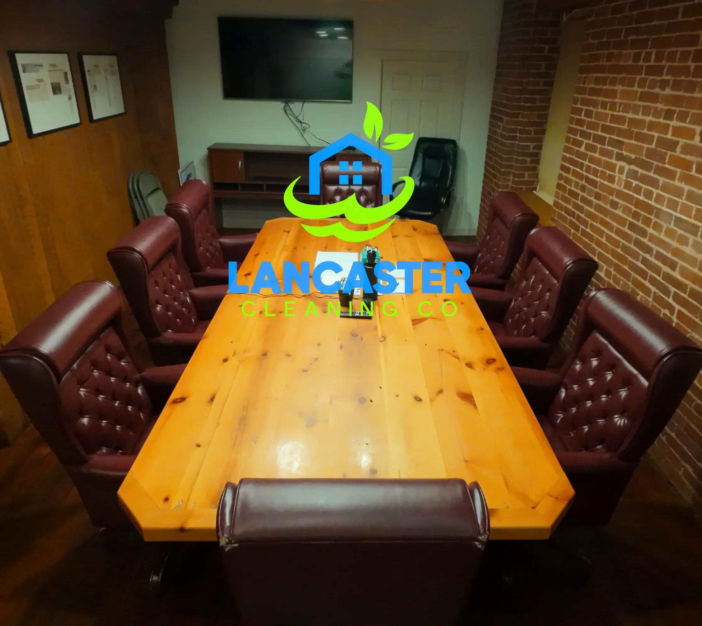 large conference table after an office cleaning performed by lancaster cleaning co. featuring clean desk chairs and hardwood flooring
