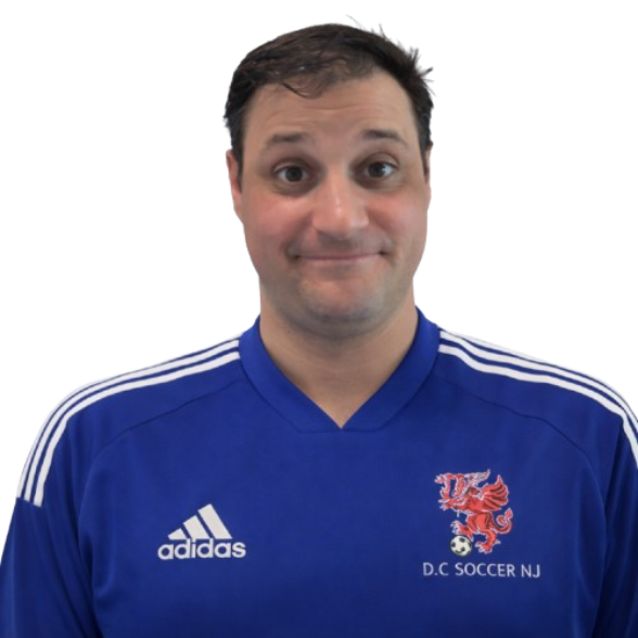 A man taking a selfie wearing a blue sports jacket with Adidas stripes and a crest on the chest.