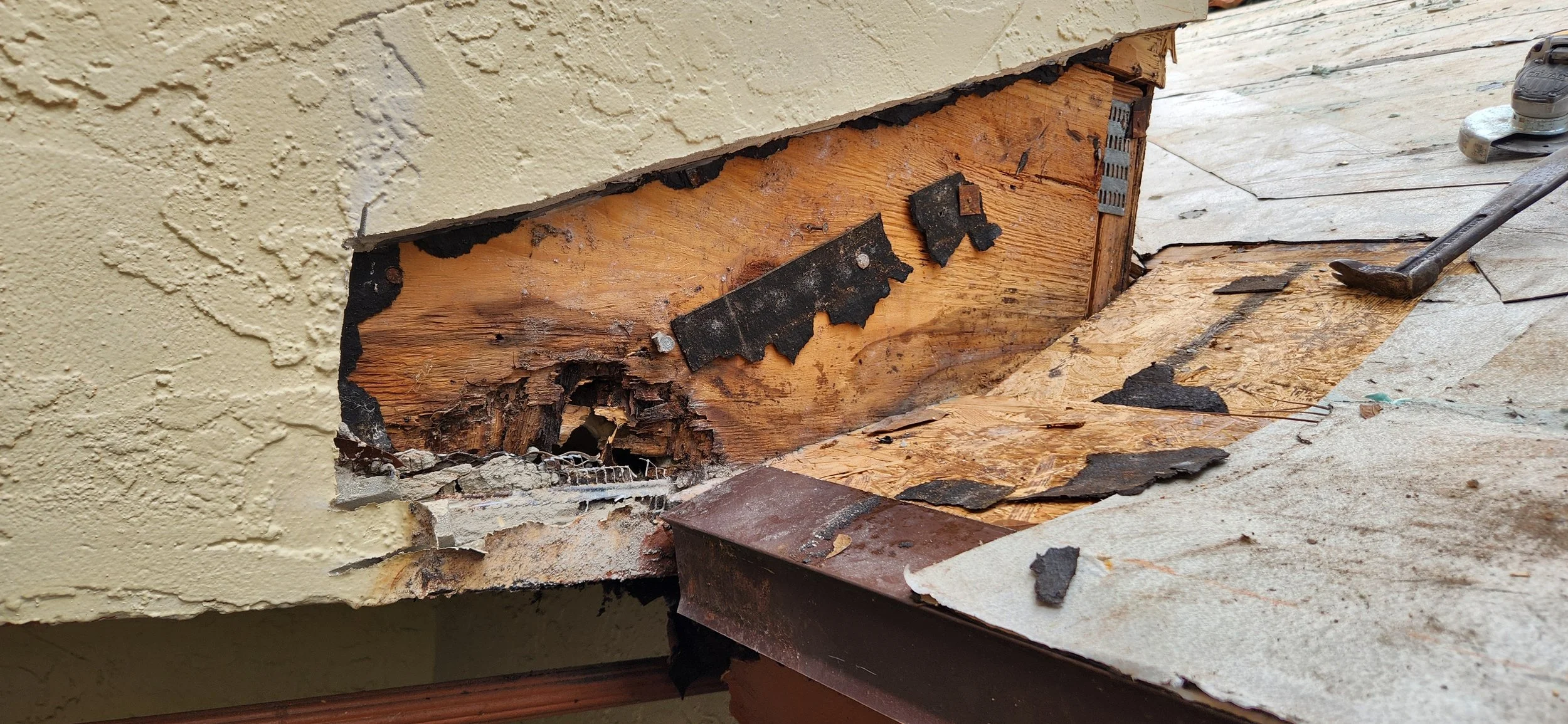 Severe wall-flashing failure where missing or improperly layered metal allowed water to run behind the roof system, causing hidden wood rot and active leaks. Once moisture gets trapped in this area, deterioration accelerates quickly — which is why Sk