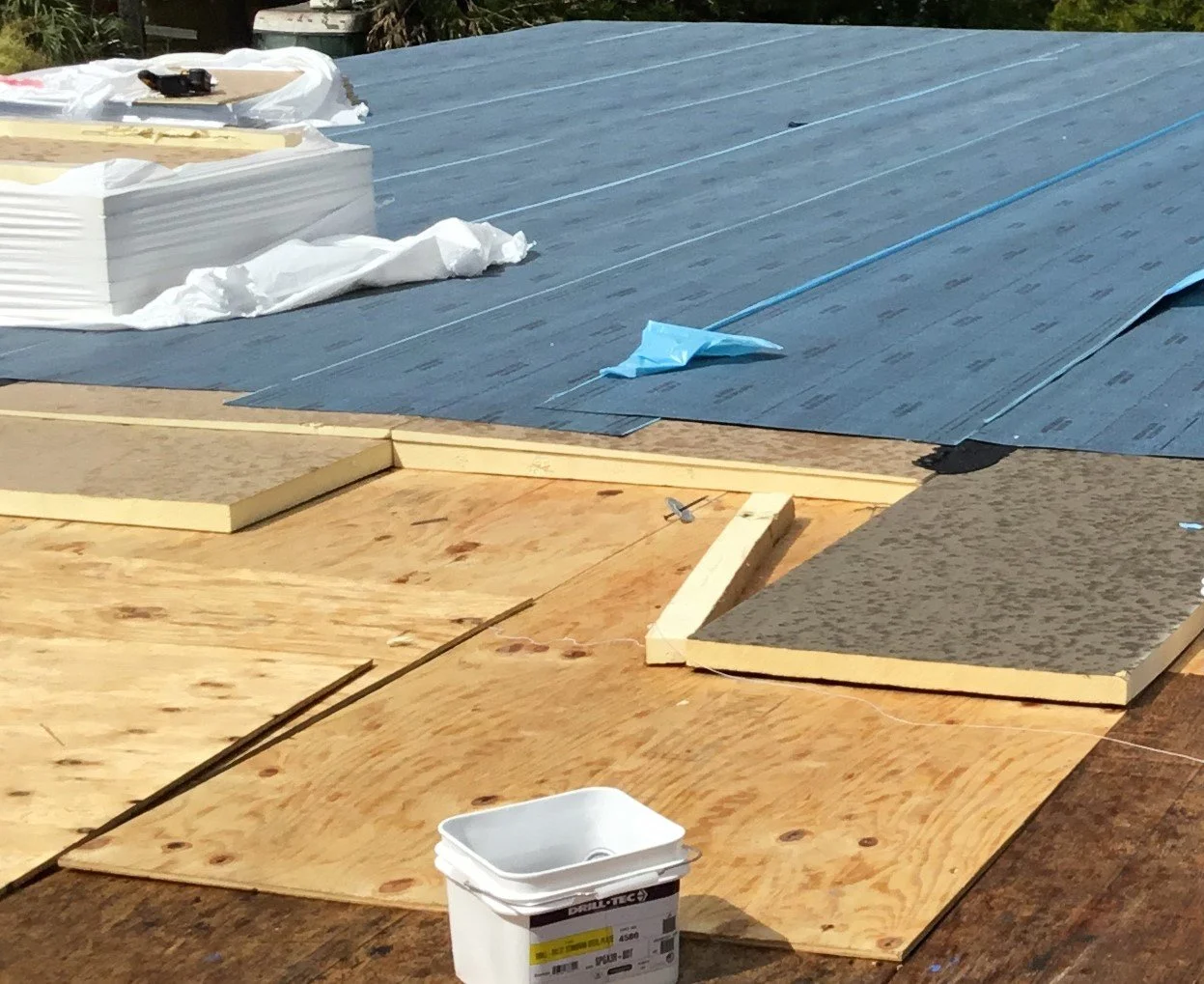 Low-slope roof where a base sheet was installed over tapered insulation to intentionally increase pitch and improve drainage. This layered approach prevents standing water, directs runoff toward proper drains, and creates a stable foundation for the 