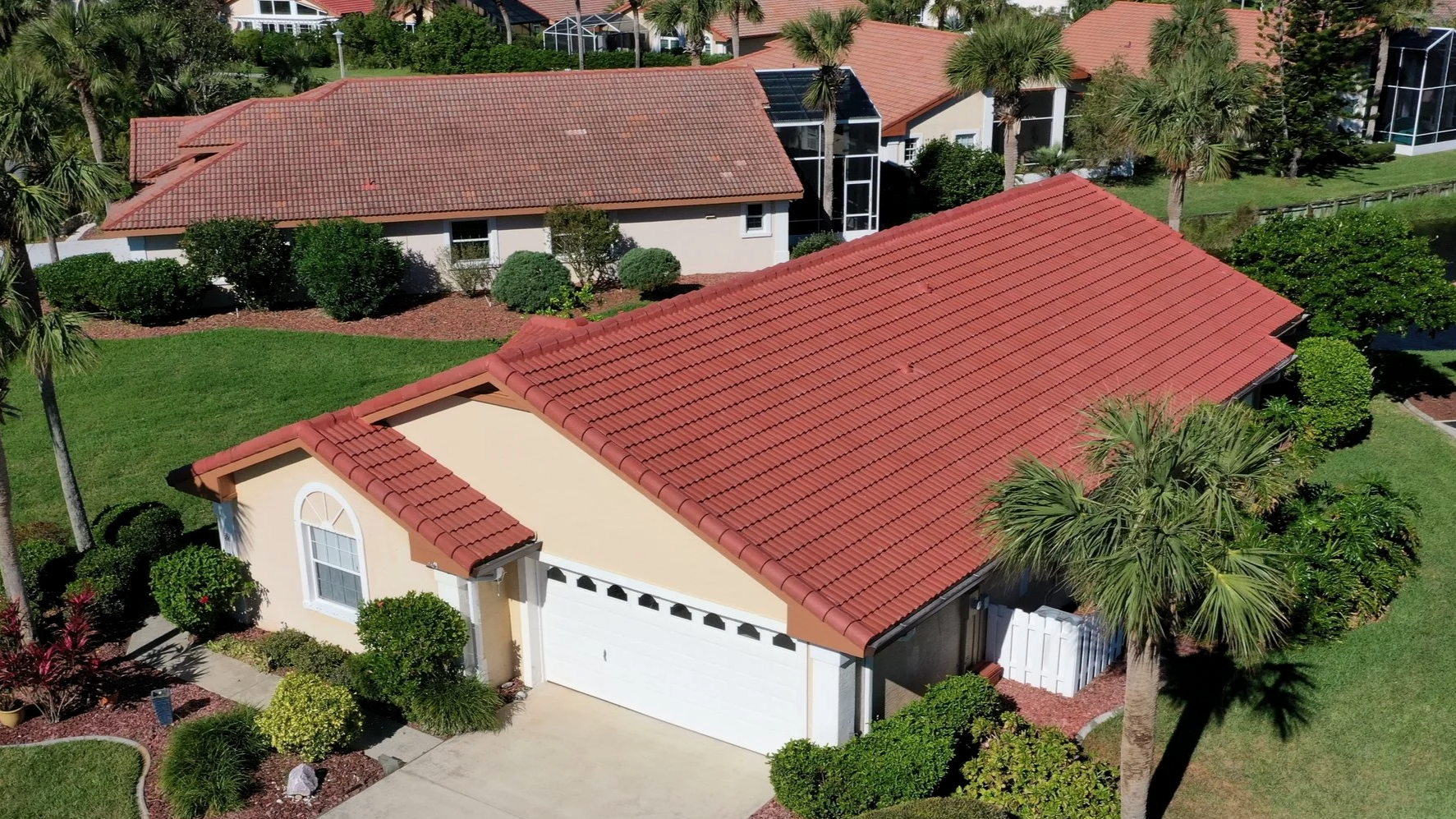 New concrete tile roof with old tile roof in background showing difference