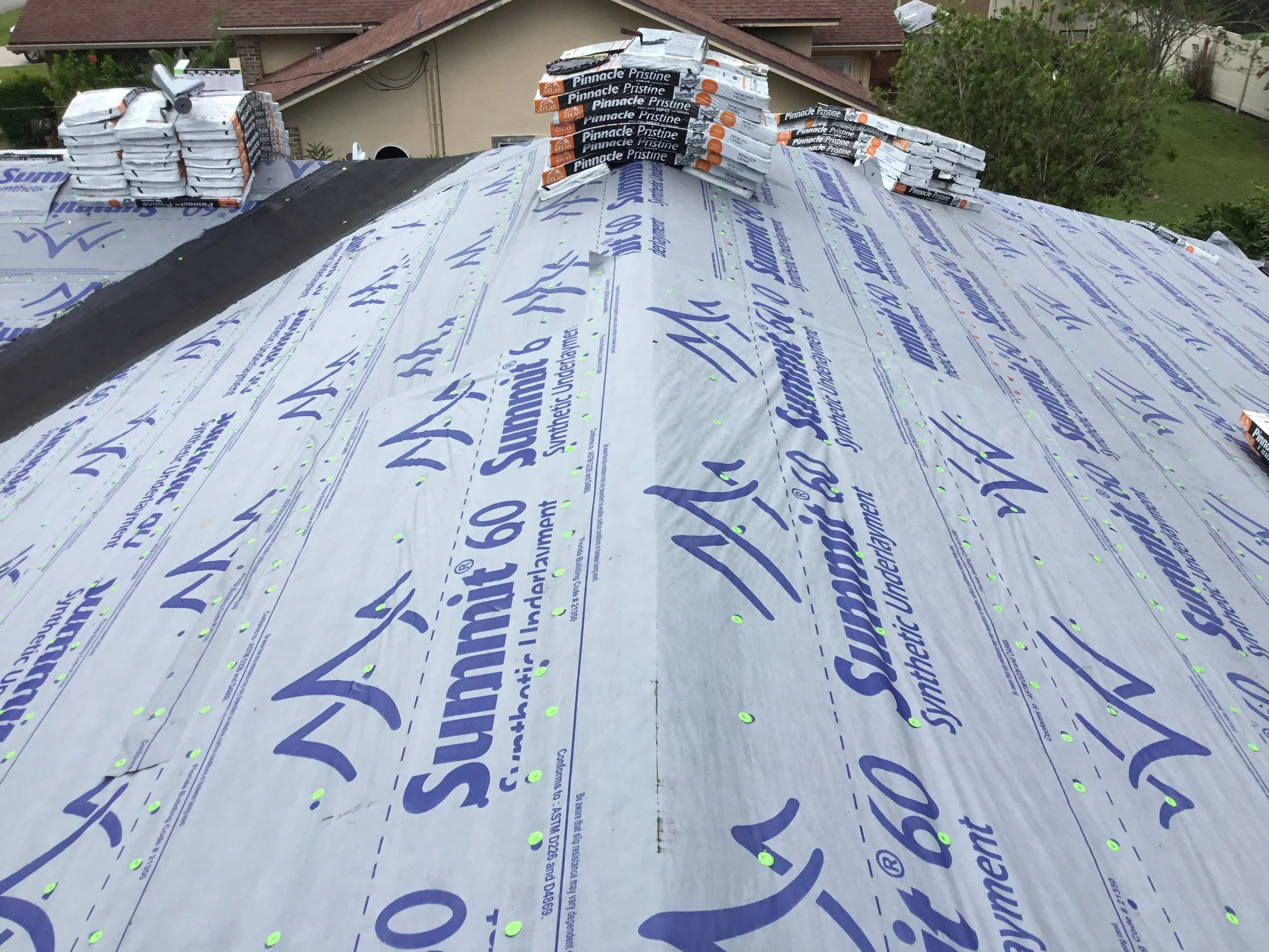 High-performance synthetic underlayment installed across the roof deck with peel-and-stick membrane properly applied in the valley as required by code. This combination creates a robust waterproofing system at the roof’s most vulnerable water channel
