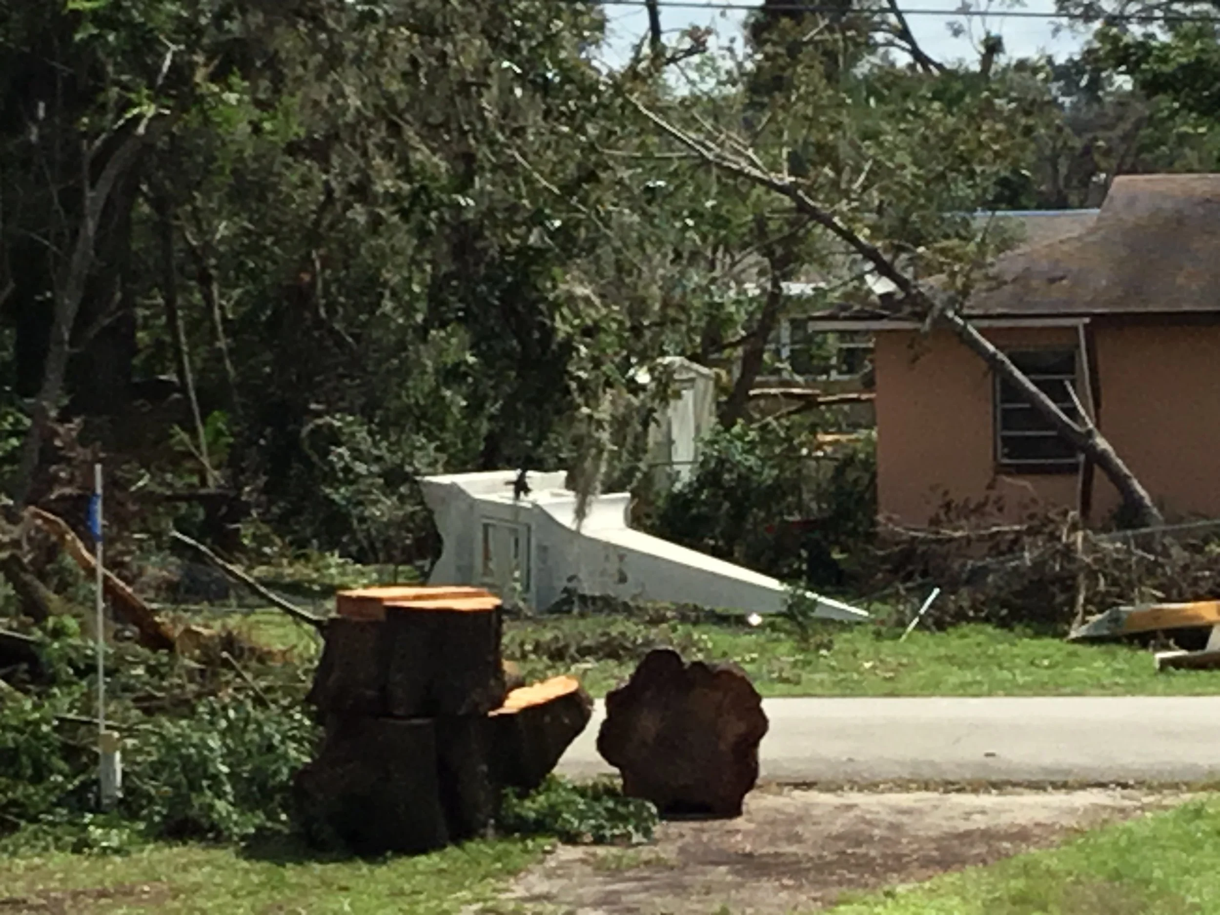 Church steeple lying on the ground in DeLand after being torn down by a powerful tornado, showing how extreme winds can compromise even heavily built roof structures. The collapse left the roof fully exposed, requiring immediate emergency response an