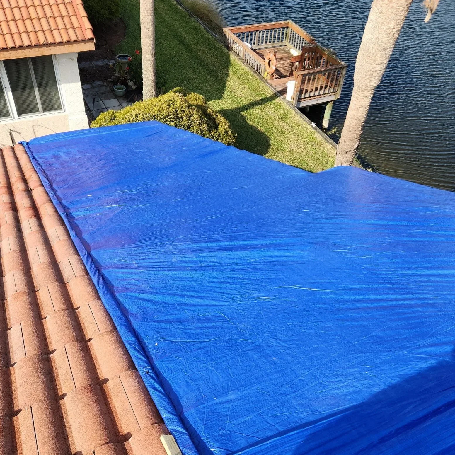 Tarp installed on concrete tile roof in Palm Coast, Florida