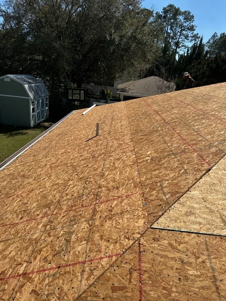 Roof fully stripped to OSB decking after tear-off, exposing the structural substrate before new underlayment and roofing are installed. This stage allows detailed inspection, board replacement where needed, and proper fastening — ensuring a solid fou