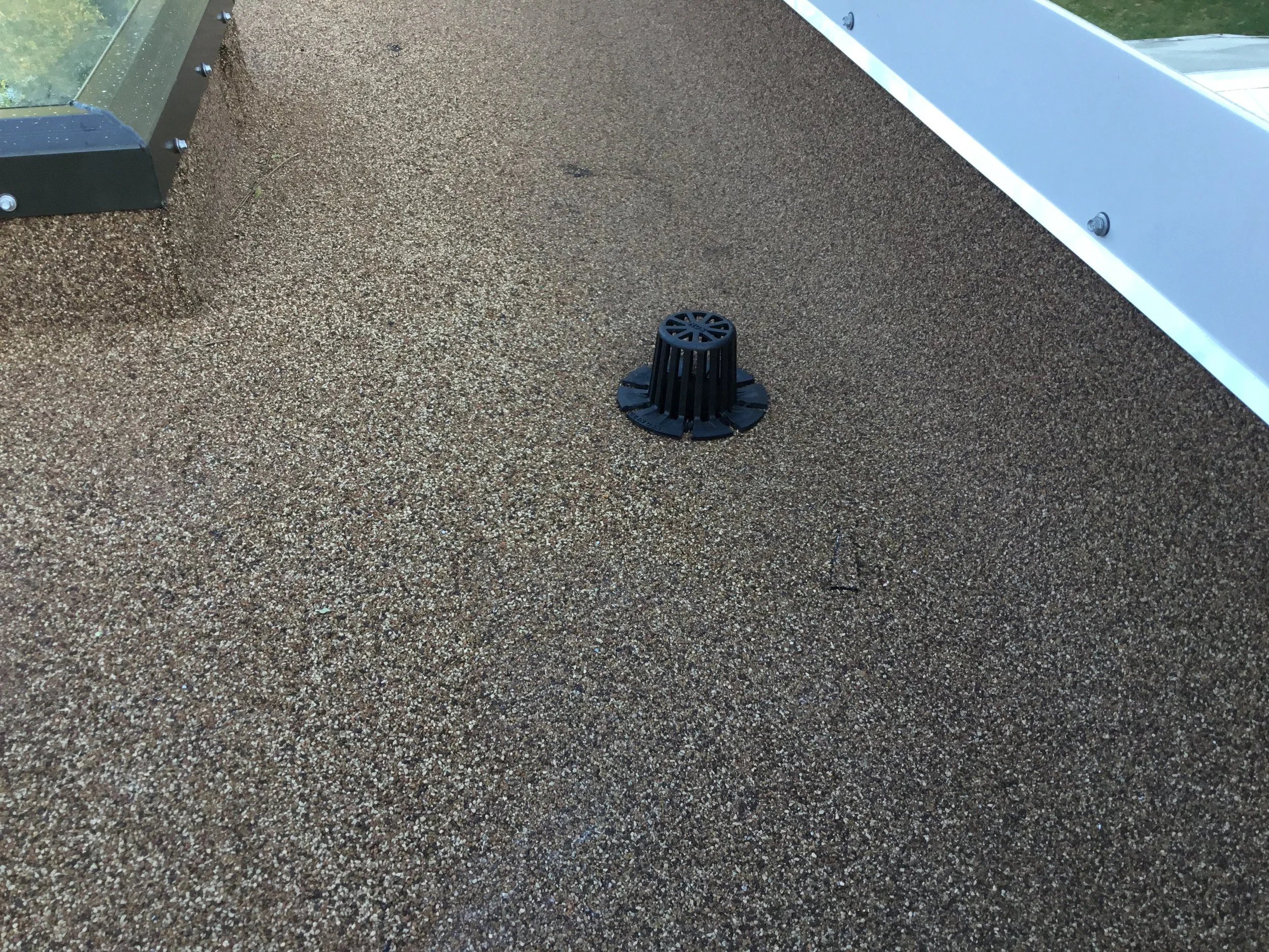 Properly installed scupper on a low-slope flat roof, designed to safely discharge rainwater off the roof edge and prevent ponding. This controlled drainage detail protects the membrane, reduces hydrostatic pressure, and helps extend the service life 