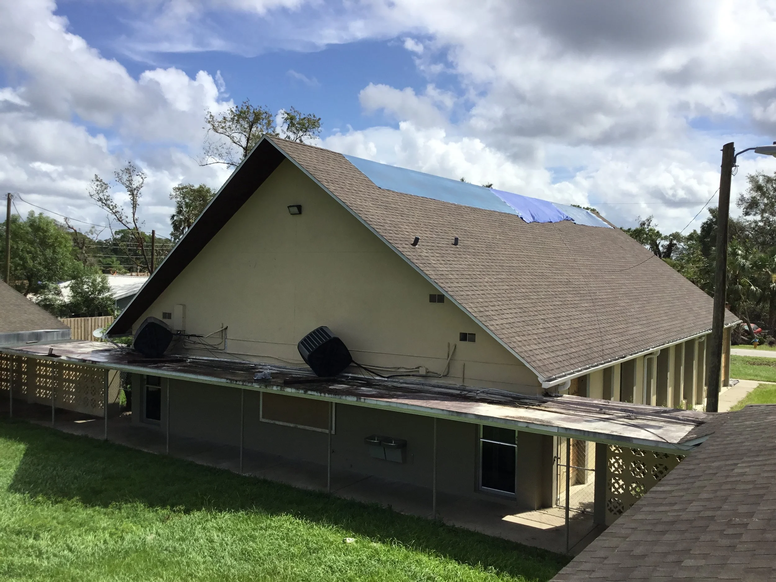 Church in DeLand temporarily tarped after tornado damage, protecting the interior while a full roof replacement was planned and executed. Emergency tarping like this prevents further water intrusion and buys critical time so repairs can be done corre