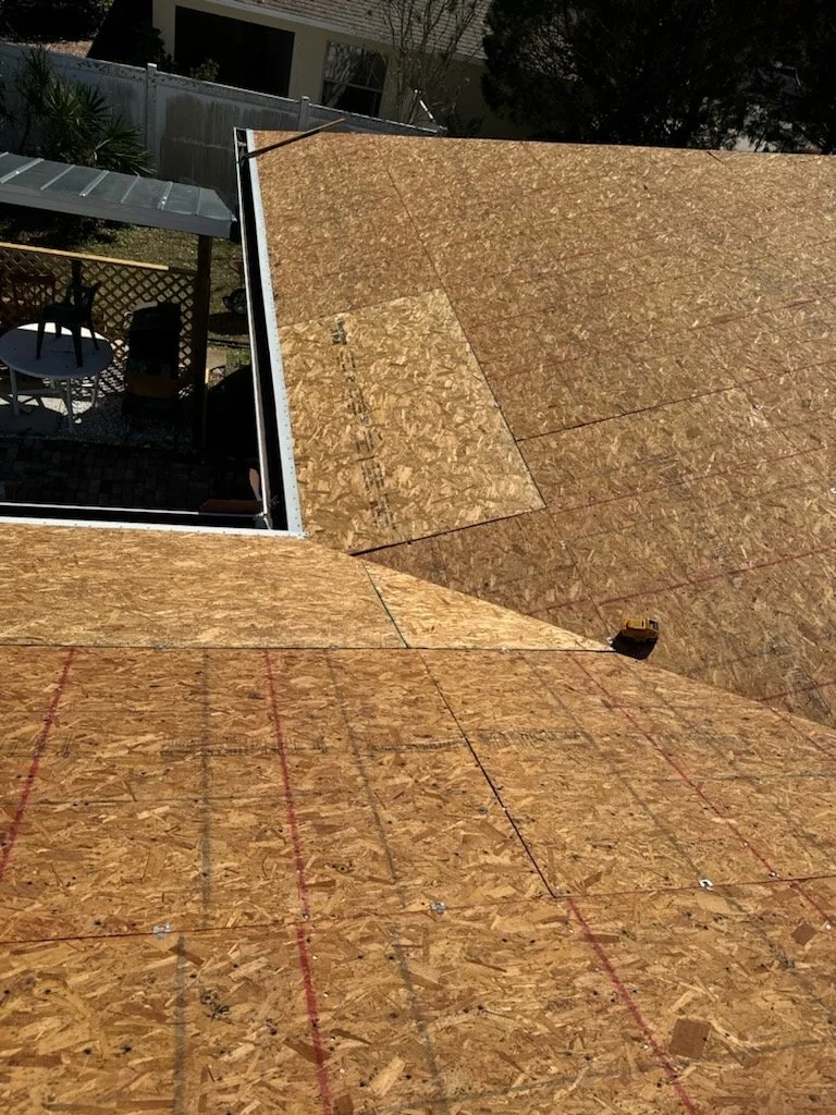 Roof stripped down to OSB plywood decking after tear-off, revealing a clean structural base before new materials are installed. This stage allows for detailed inspection, damaged board replacement, and proper fastening — ensuring a solid foundation f