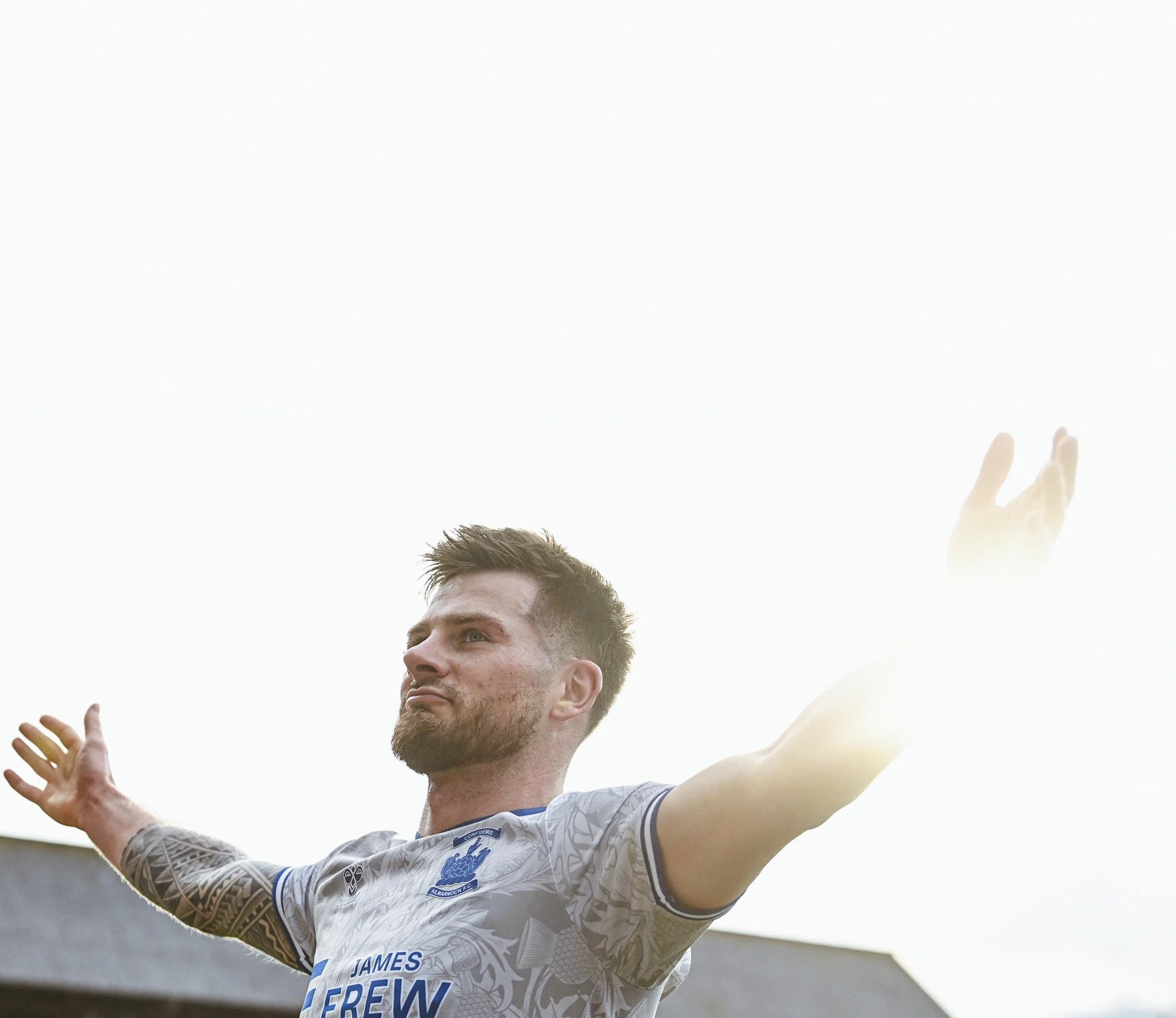 rofessional soccer player celebrating goal in Scottish league match