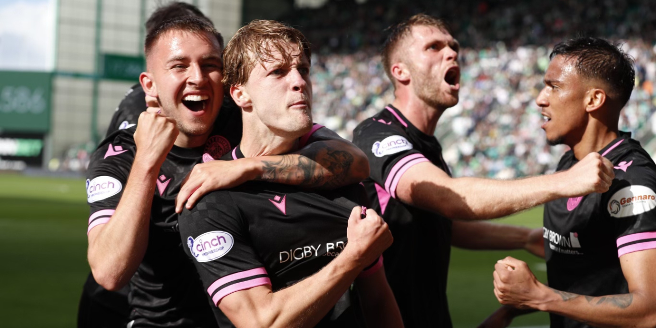 Alex Greive celebrating a goal with St Mirren FC teammates in black and white striped kit in Scottish Premiership