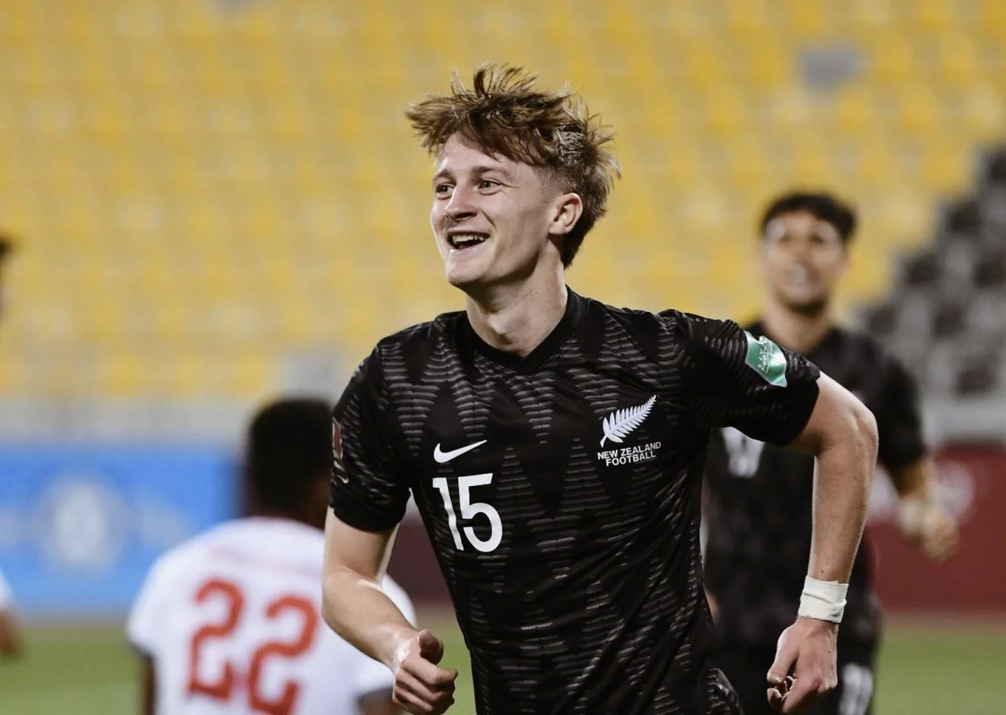 Alex Greive celebrating in New Zealand All Whites black kit number 15 during international match
