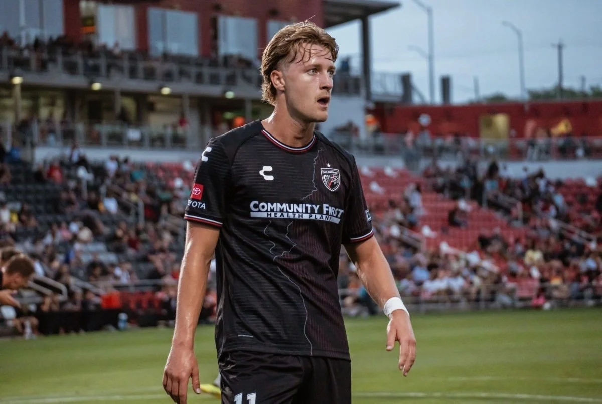 Alex Greive standing in San Antonio FC black kit at Toyota Field in USL Championship match