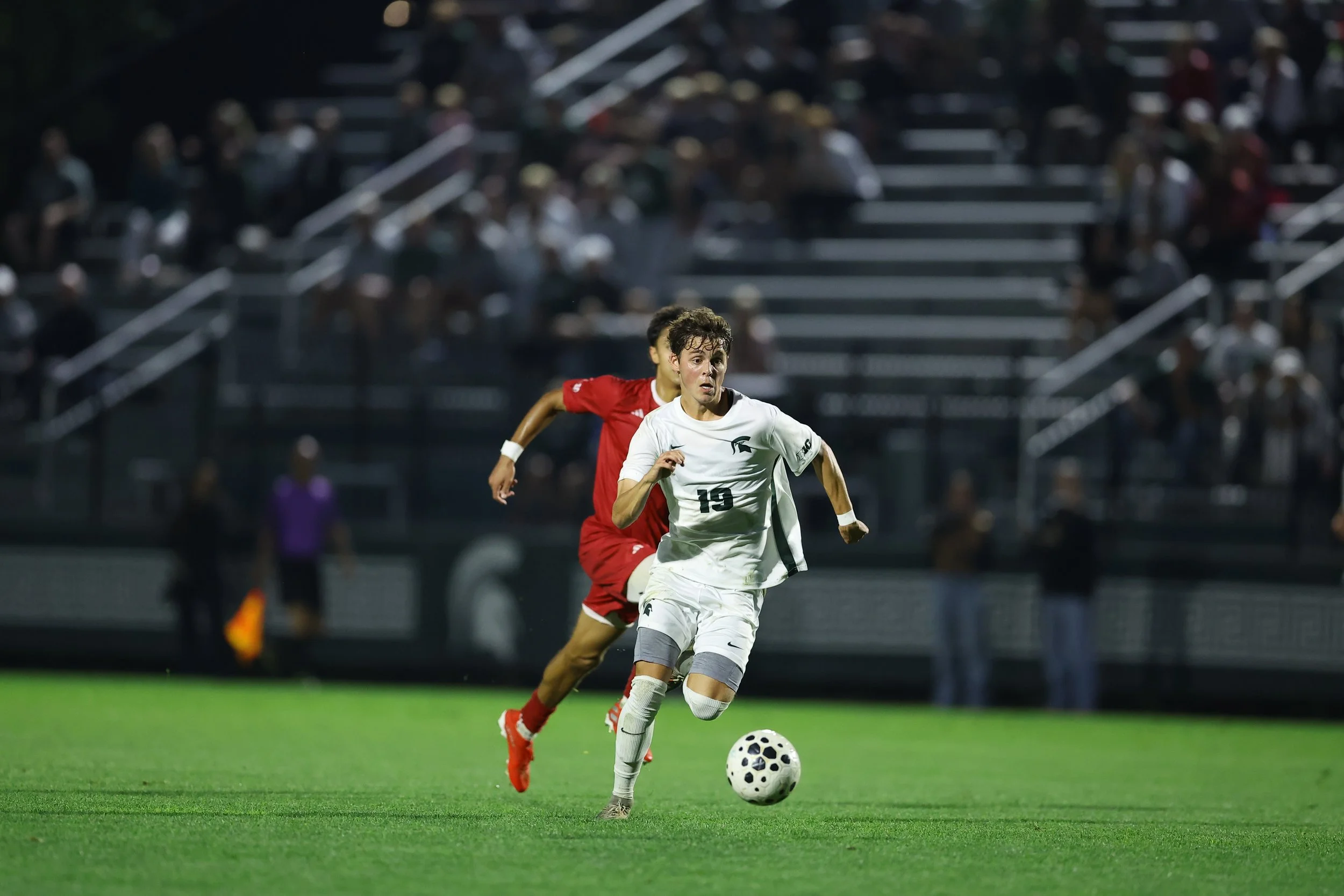 Jack Guggemos playing college soccer for Michigan State
