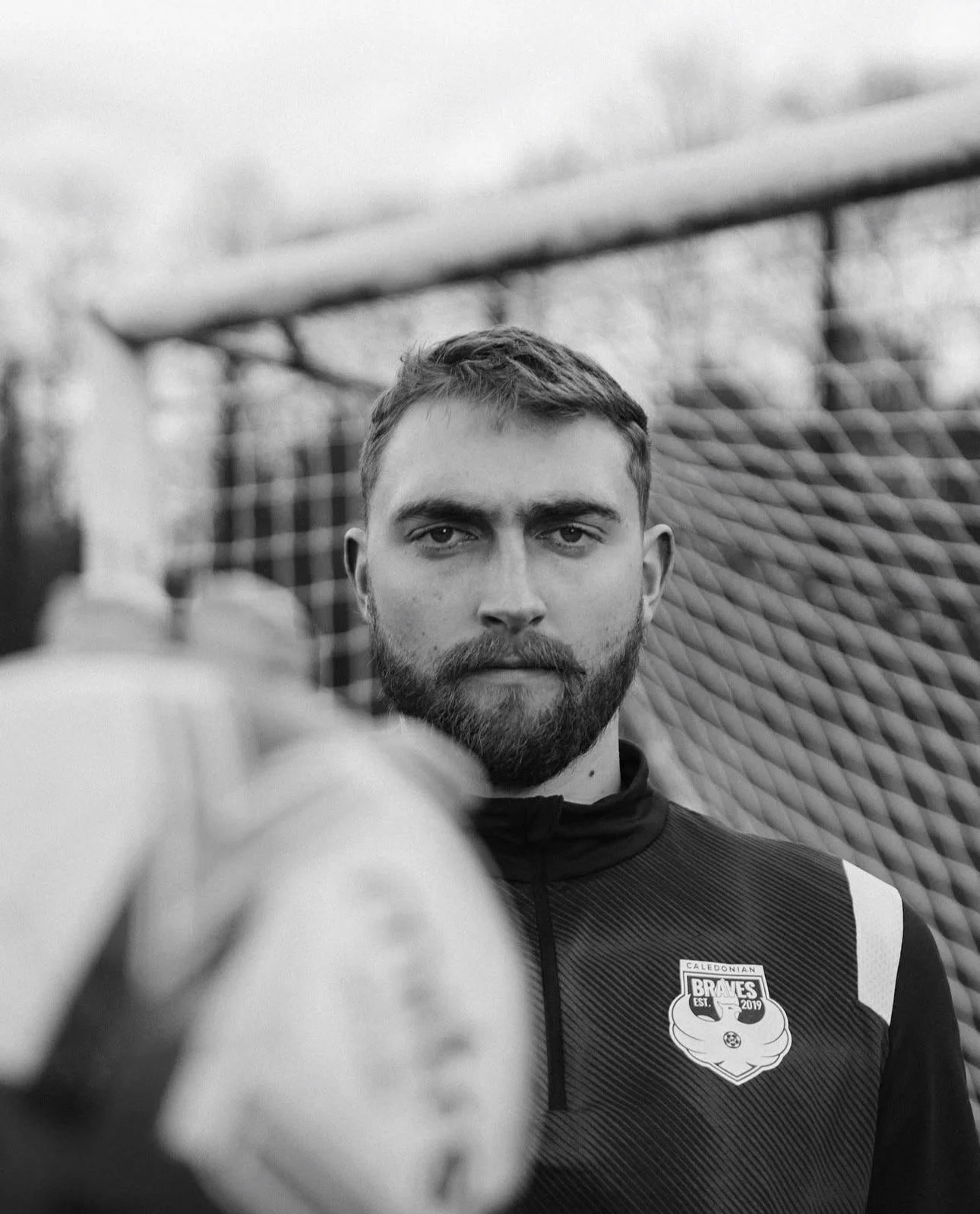 Bernie White in goalkeeper kit standing at stadium - former NCAA Division III player now in Scotland