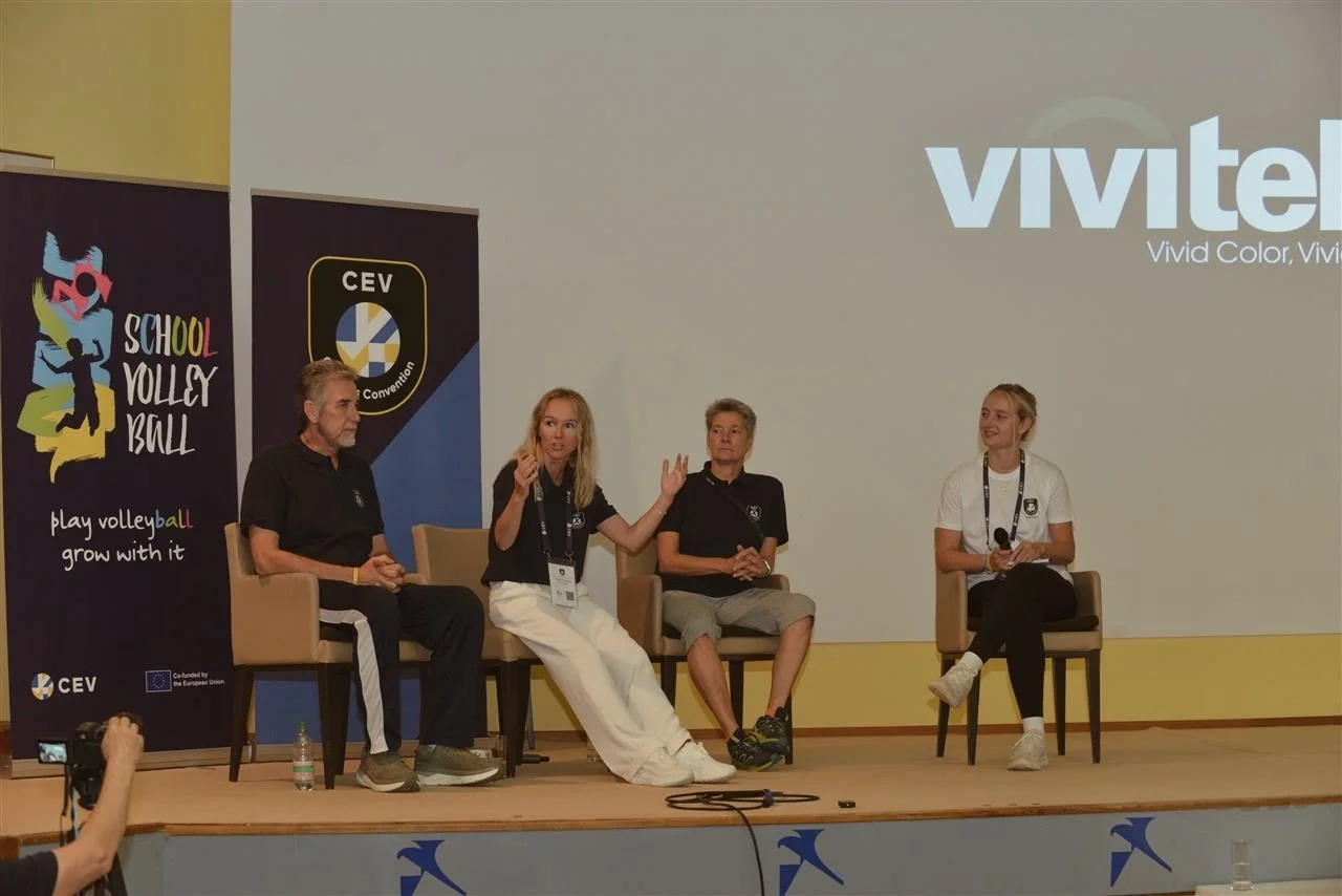 Maddy Weber participating in Vivid Volleyball panel discussion on stage with other speakers about playing overseas