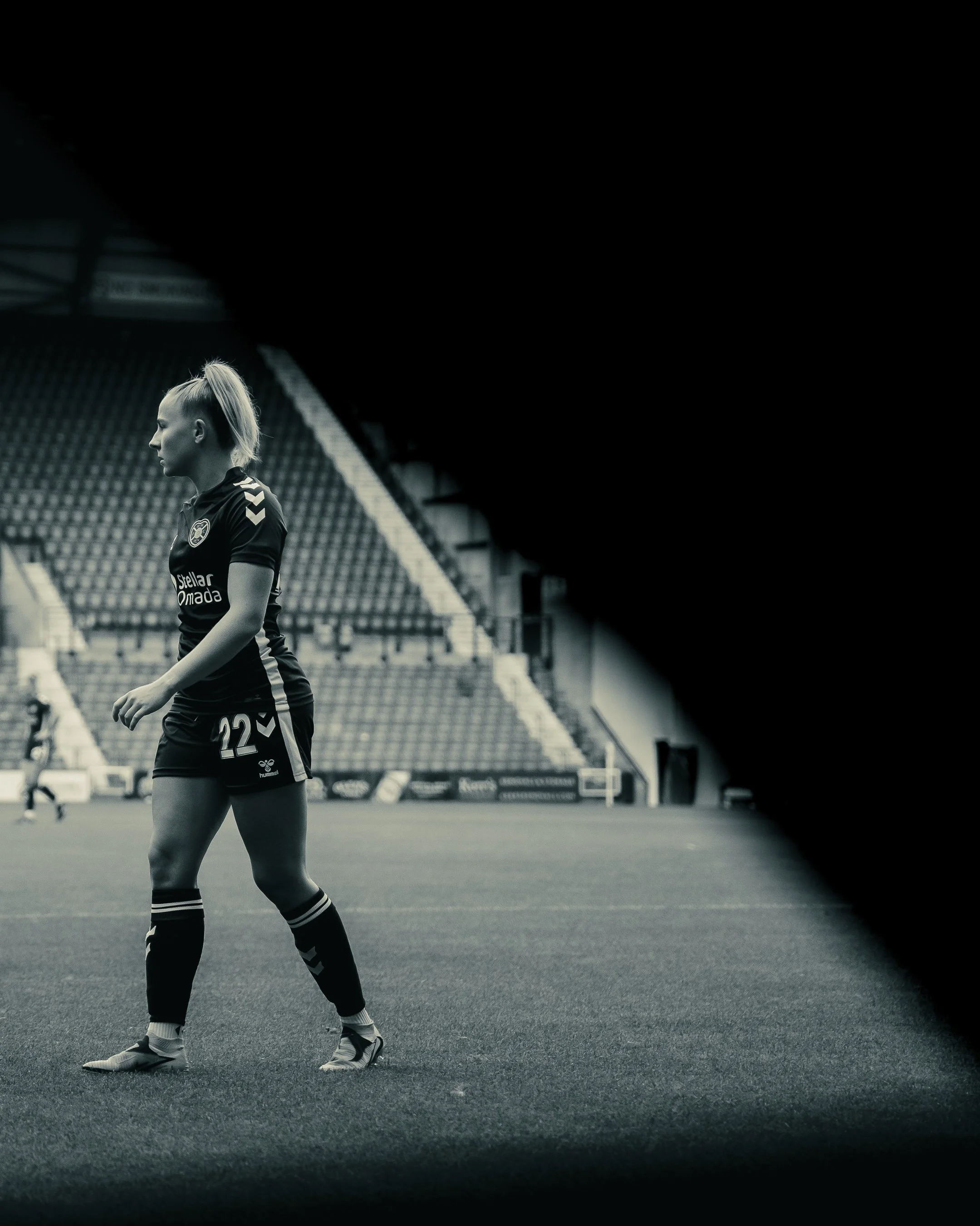 Hibernian and Hearts players competing in a women's football match in Scotland