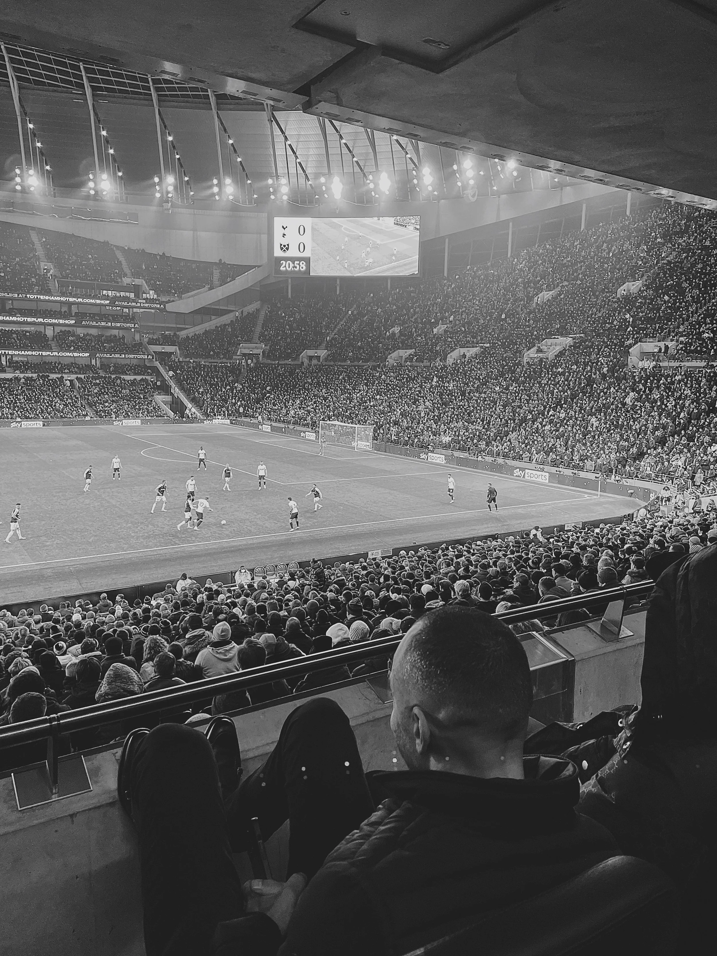 Historic Scottish soccer stadium with crowd watching professional match