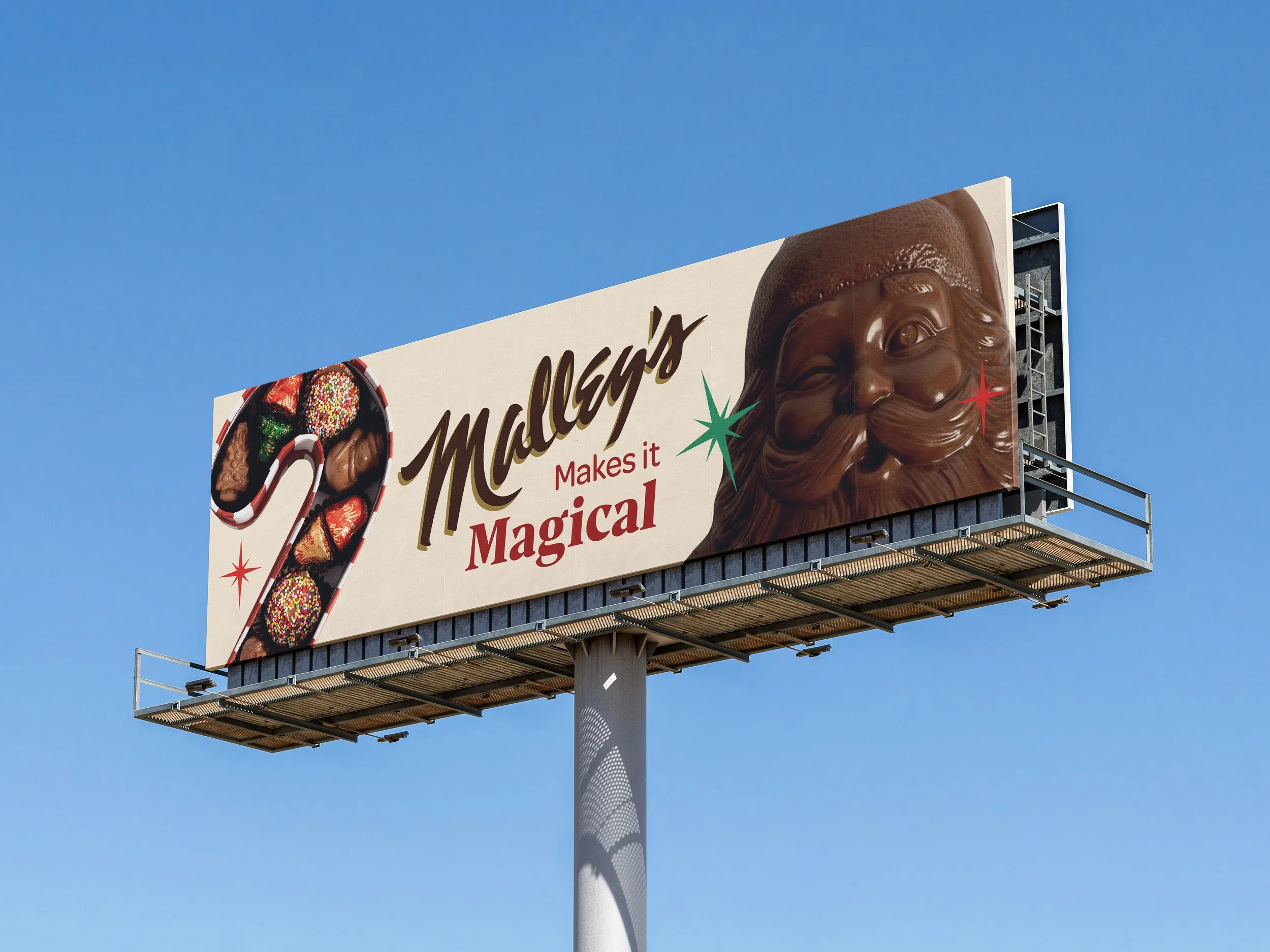 Billboard advertisement for Malley's displays a large chocolate Santa face and a candy cane filled with assorted chocolates, with the text 'Malley's Makes it Magical' against a blue sky.