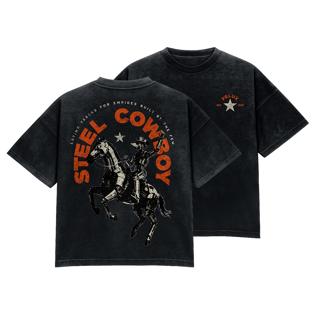 Two black T-shirts with a graphic stylized image of a character riding a robot horse with the text 'STEL COBBOY' in orange and a subtitle 'LAZING TRACKS FOR EMPIRES BUILT BY THE FEW.'