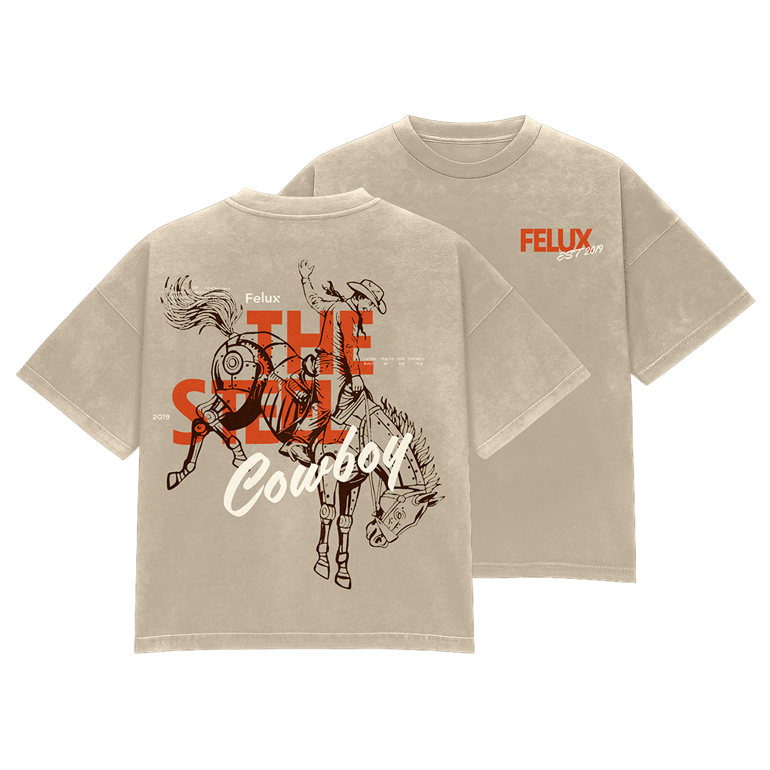 Gray T-shirt with cowboy riding a bucking horse graphic, orange and white text, and design elements.