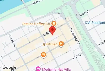 Map highlighting streets and landmarks including Station Coffee Co, Jj Kitchen, and Medicine Hat Villa, near the IGA Foodland on 2nd Street SE and South Railway Street.