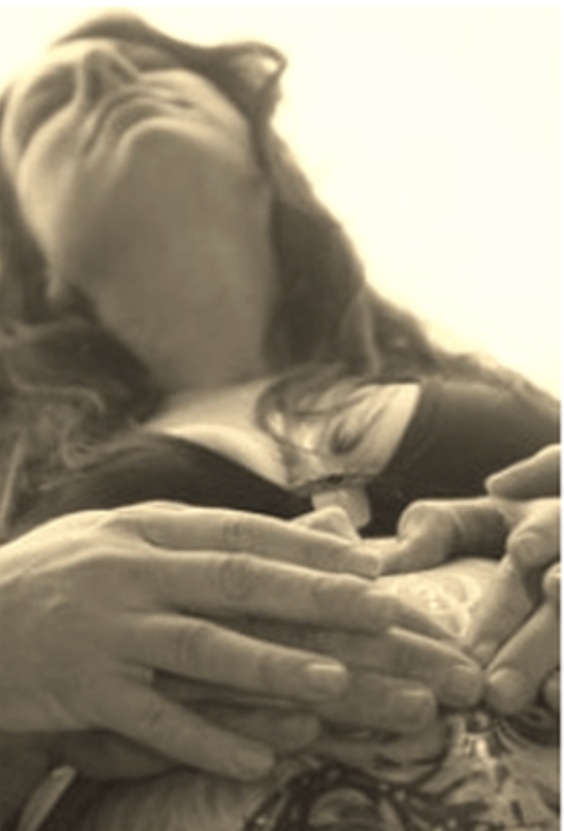 A woman lying down with her hands clasped, seen from a low angle in sepia tone.