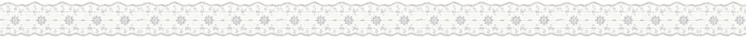 Close-up of a piece of fabric with a lace trim and a floral pattern.