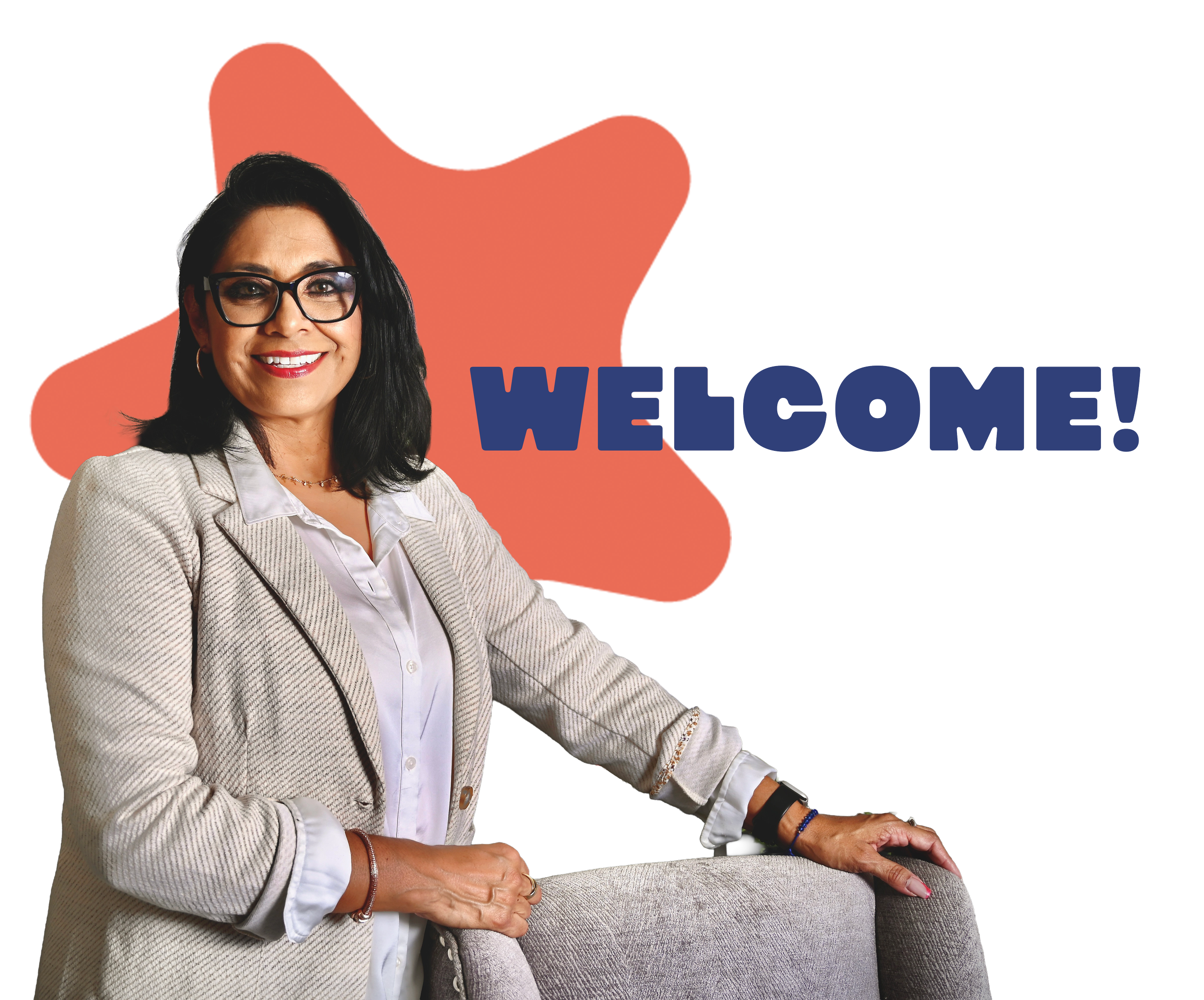 A woman with glasses and dark hair smiling, wearing a beige blazer and white blouse, standing in front of a coral background with large blue 'WELCOME' text.