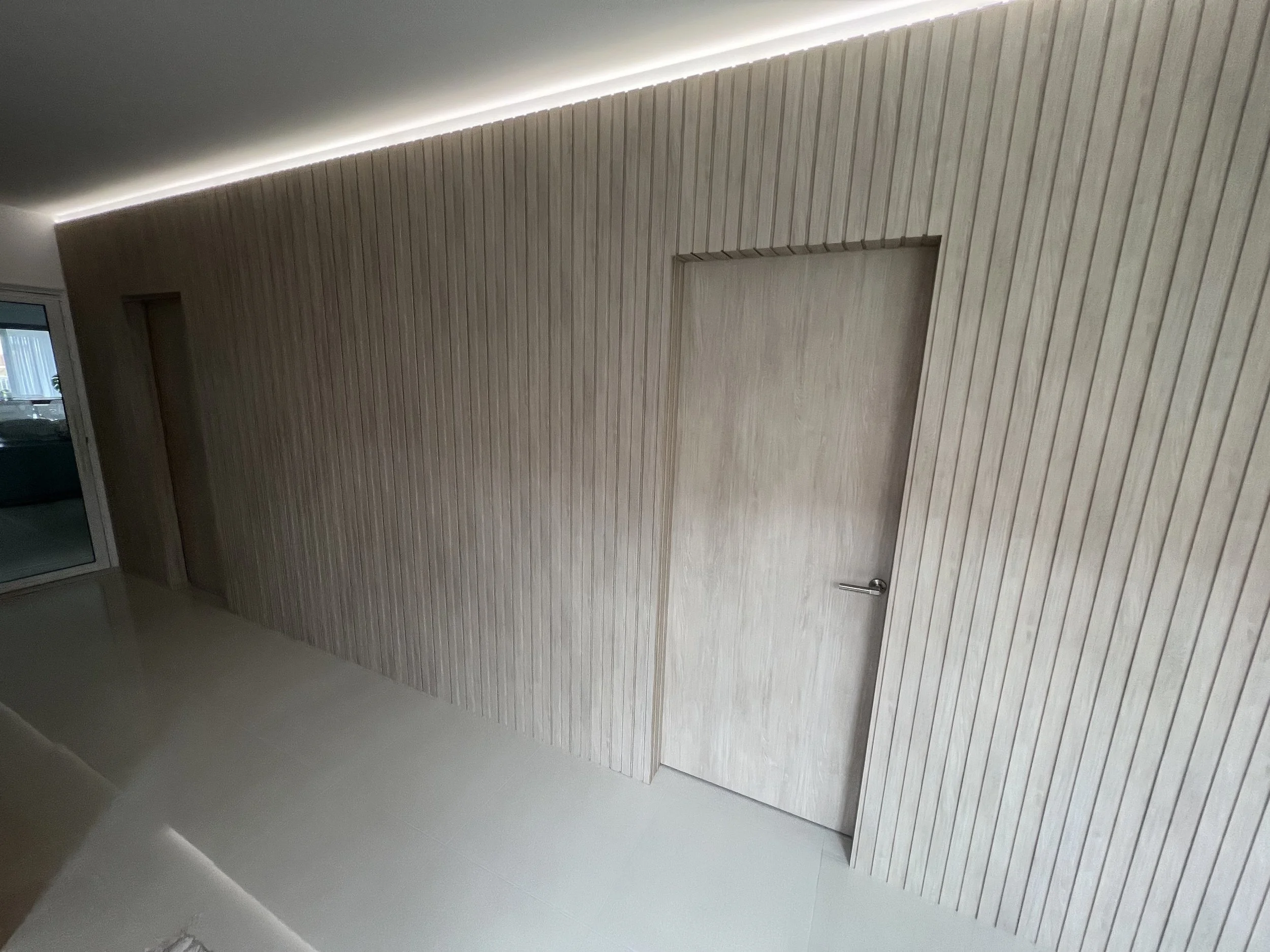 Modern hallway with wooden wall panels, built by local builder for a new custom home build