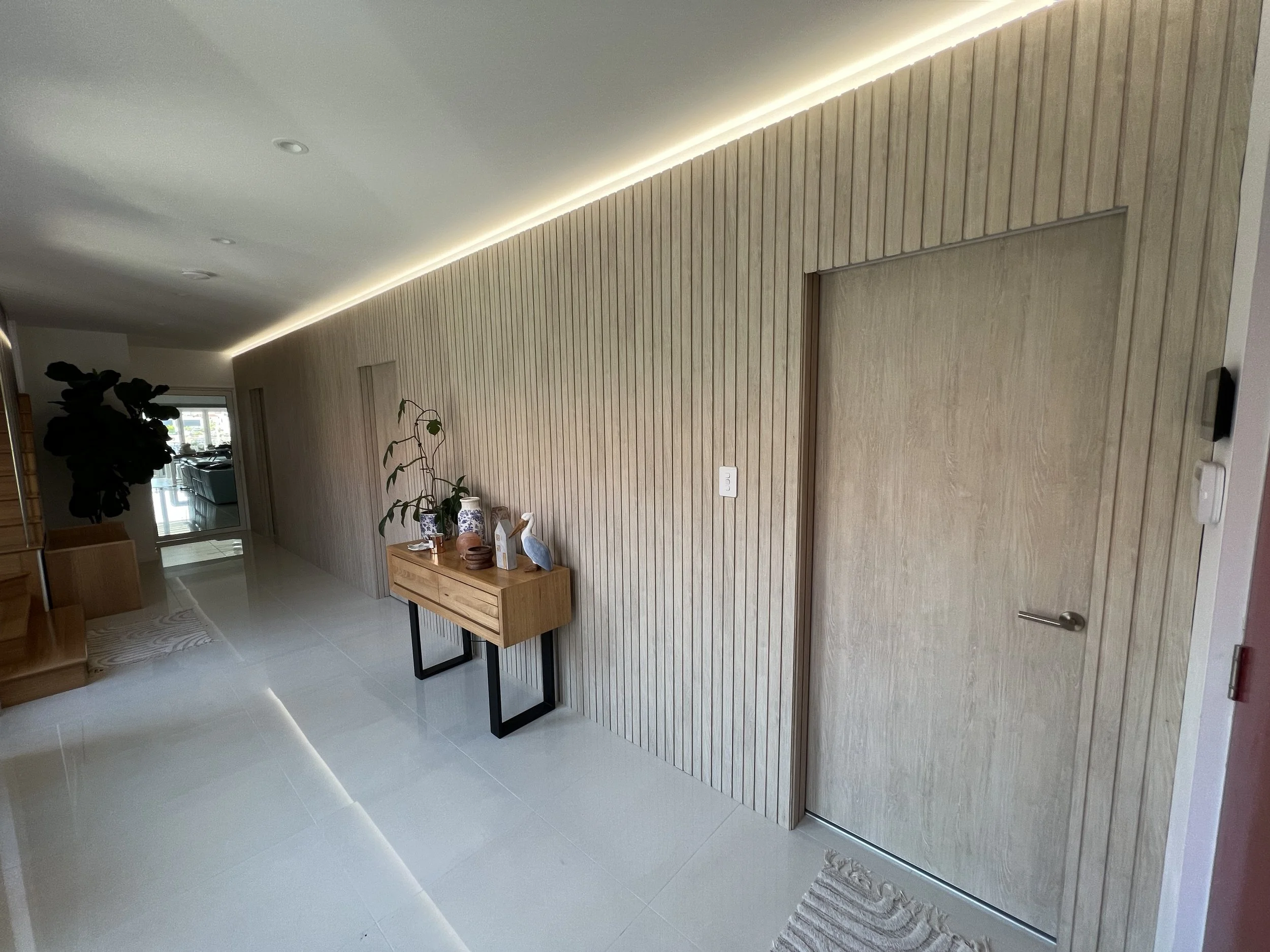 Modern hallway with wooden wall panels, built by local builder for a new custom home build