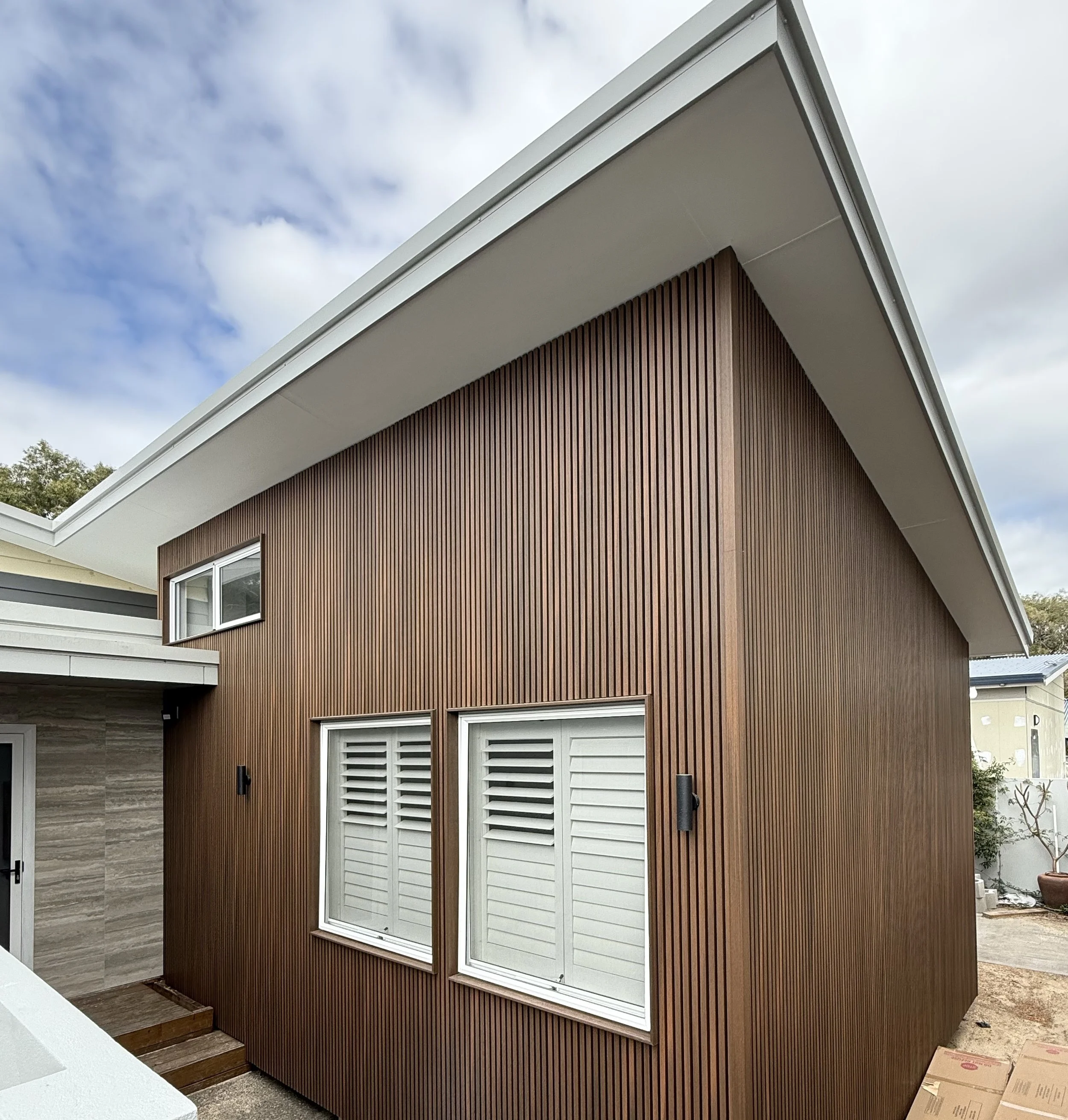 Modern house with vertical wooden panelling as home extension built by busselton builder