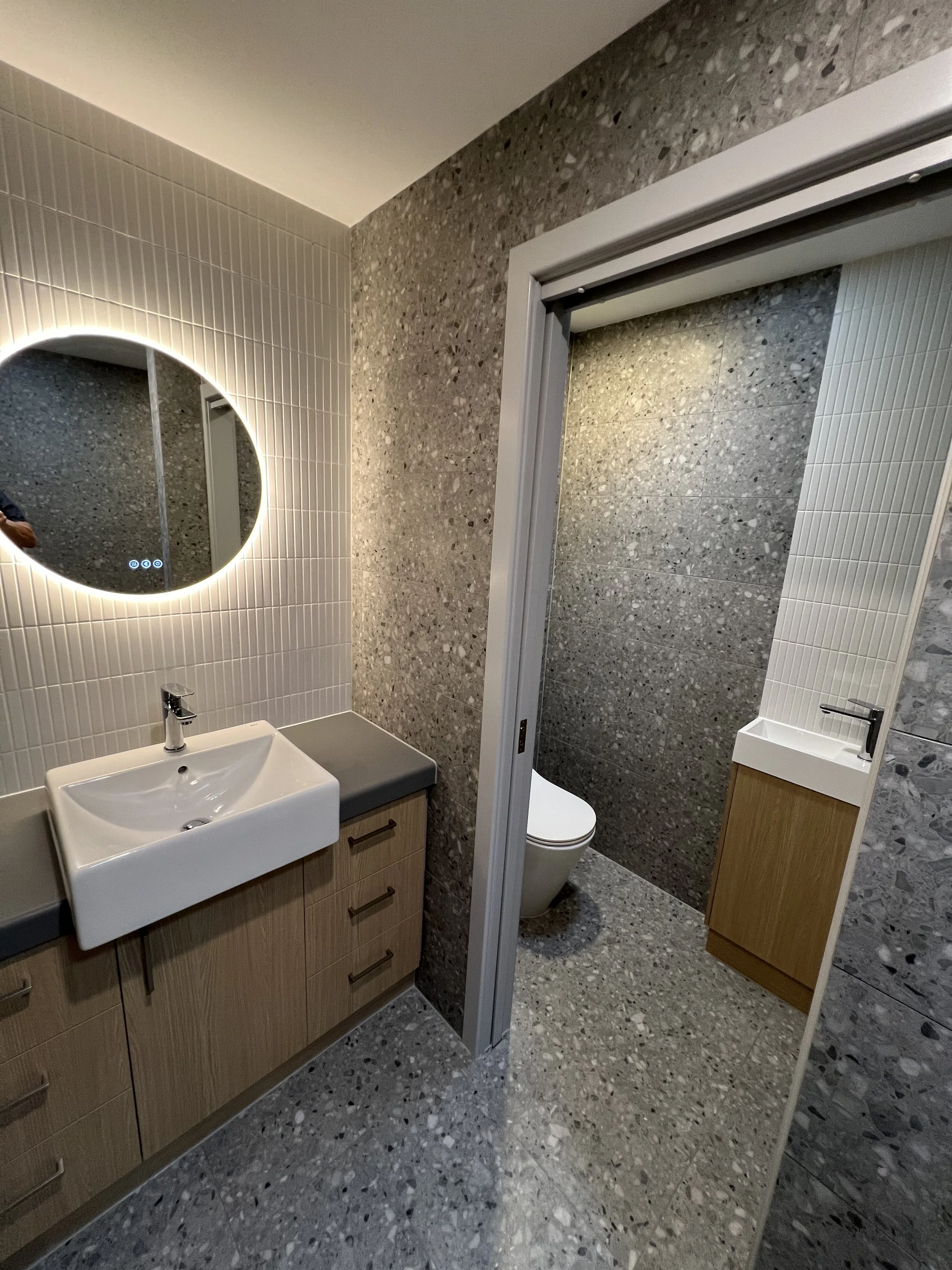 A minimalist bathroom featuring a new renovation completed by custom builders