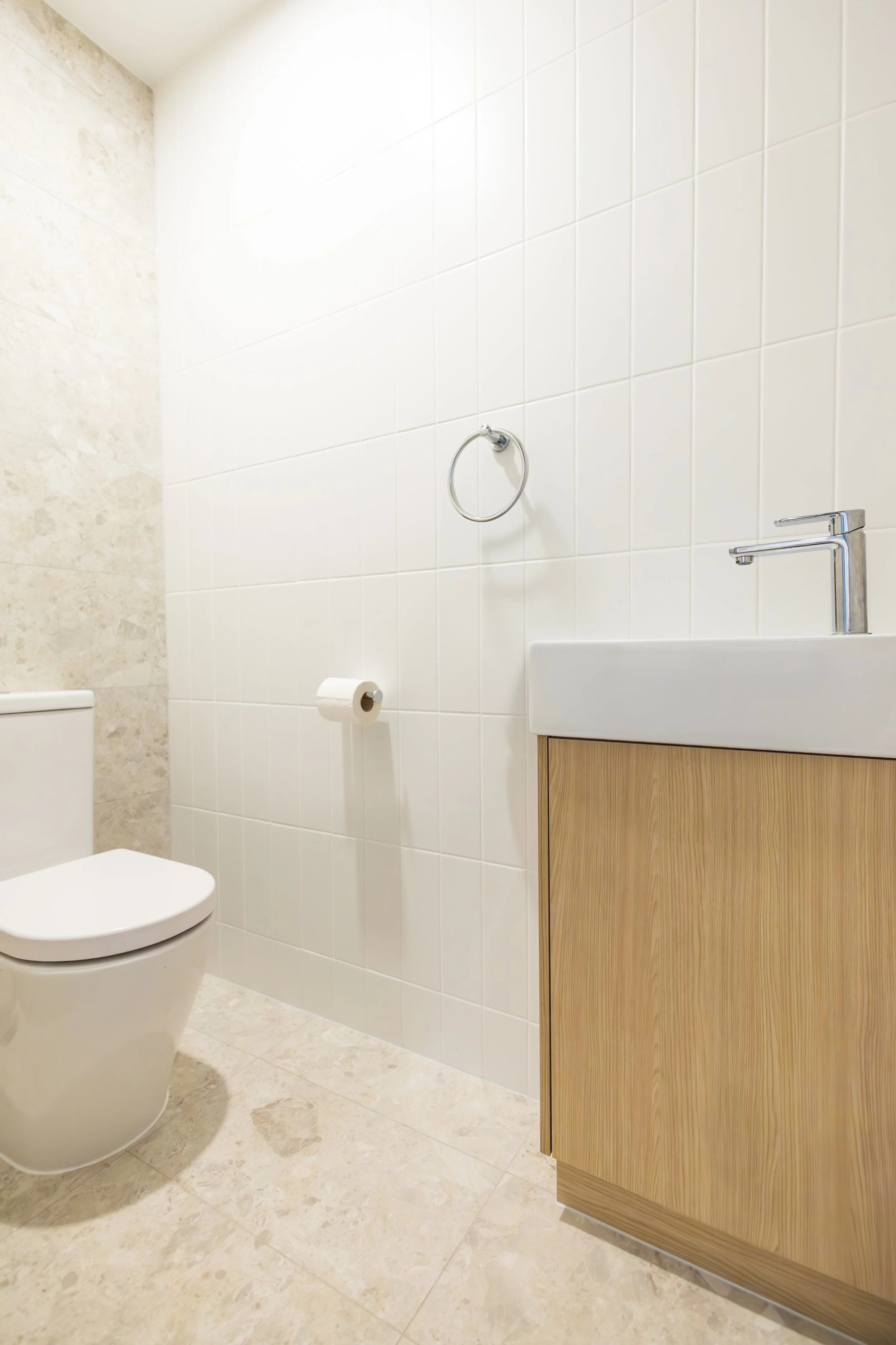 A minimalist bathroom featuring a new renovation completed by custom builders