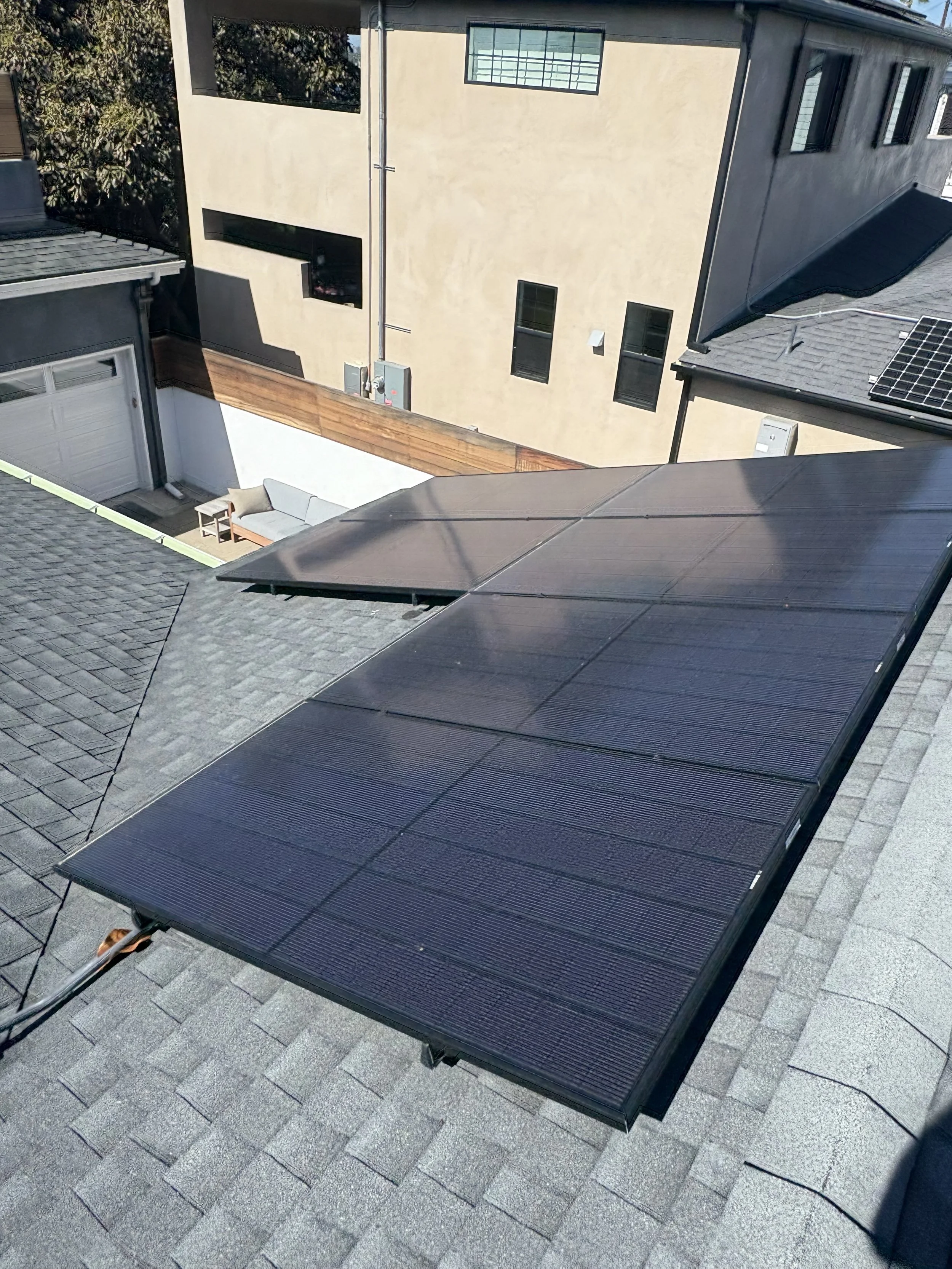 Installing solar panels on a residential roof in an urban neighborhood.